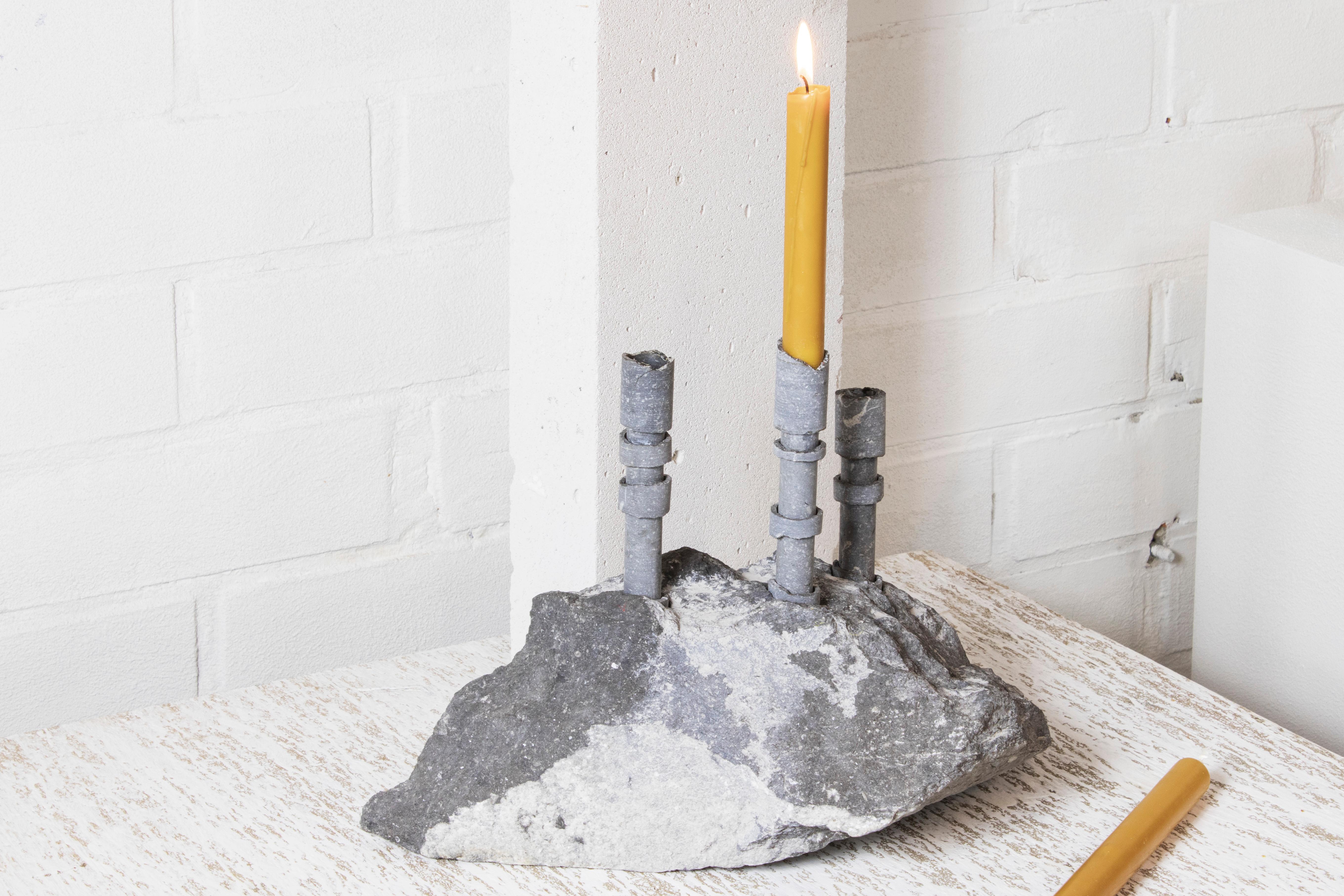 Blue Stone Abra Candelabra by Studio DO
Dimensions: D 41 x W 20.5 x H 19 cm
Materials: Blue stone, aluminum.
12 kg.

Stone and fire are connected in an ageless bond. A sparkle created by clashing two stones with each other has been igniting fire