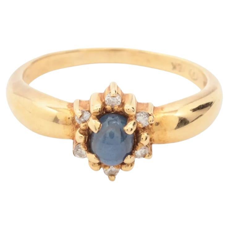 Anello in oro con diamante e pietra blu