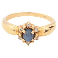 Anello in oro con diamante e pietra blu