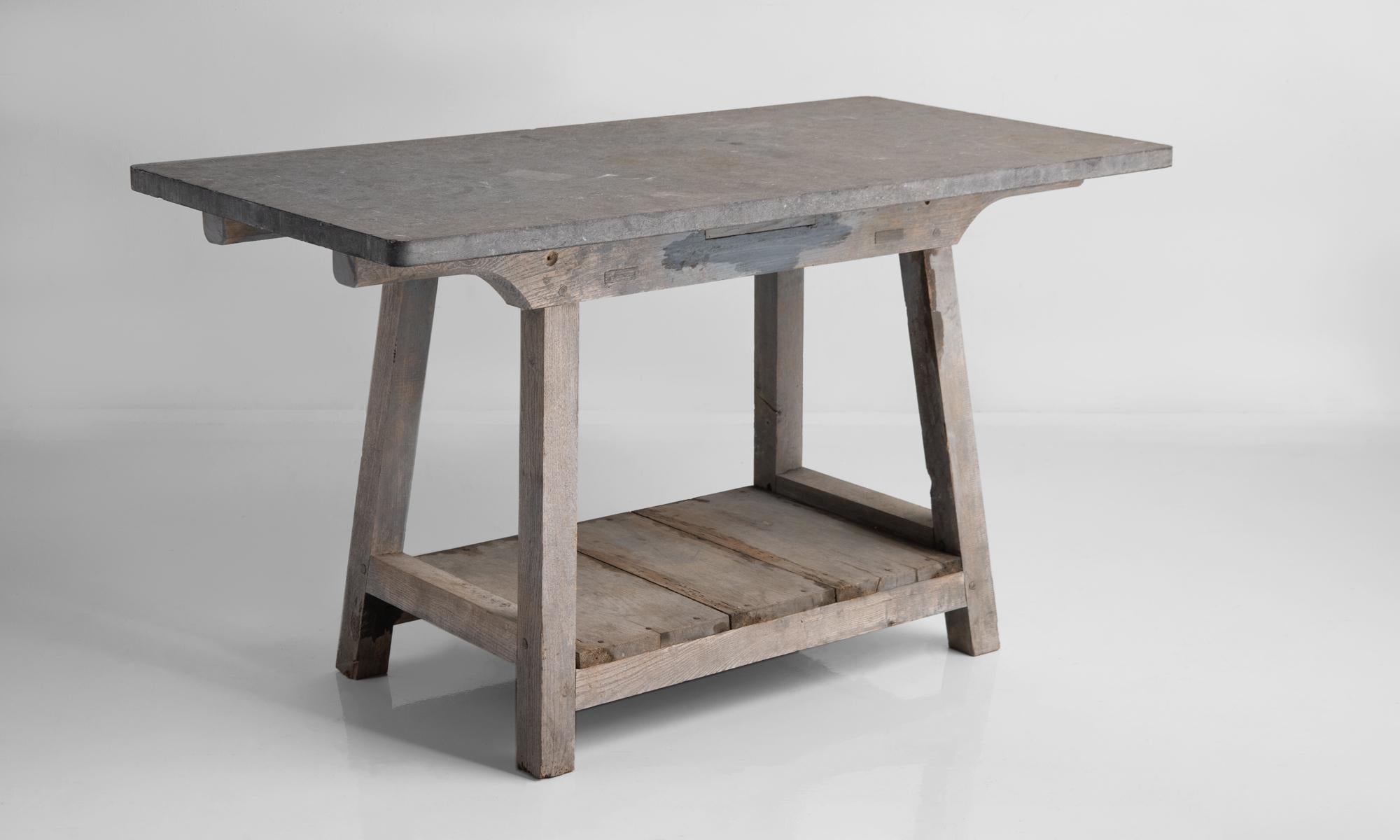 Blue stone top work table, France, circa 1900.

Oak base in original period finish with blue stone top.

 