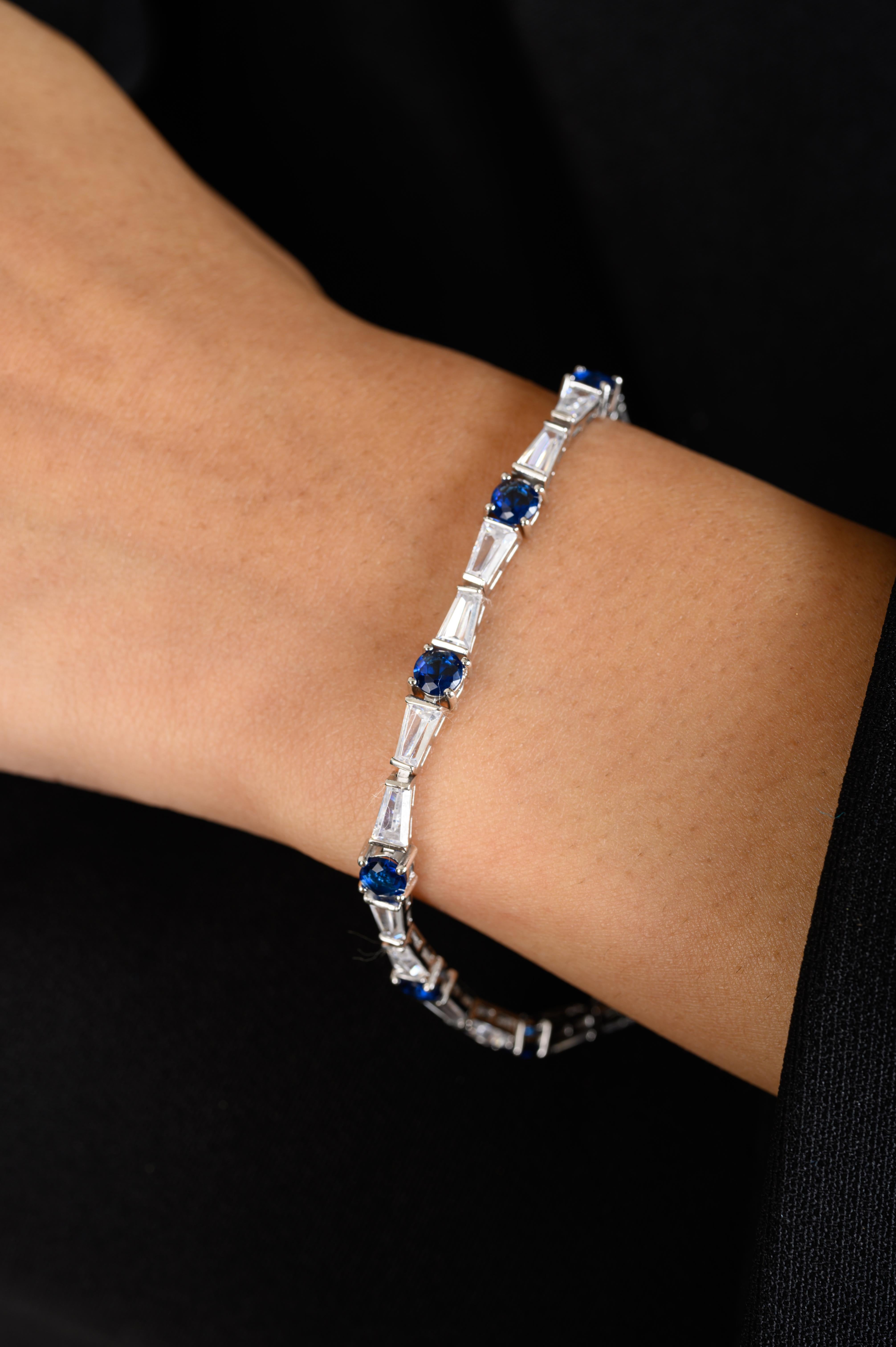 Blue Stone Zircon Tennis Engagement Bracelet in sterling silver. You shall need statement tennis bracelet to make a statement with your look. Each piece features dazzling cubic zirconia stones, renowned for their brilliance and clarity, set in