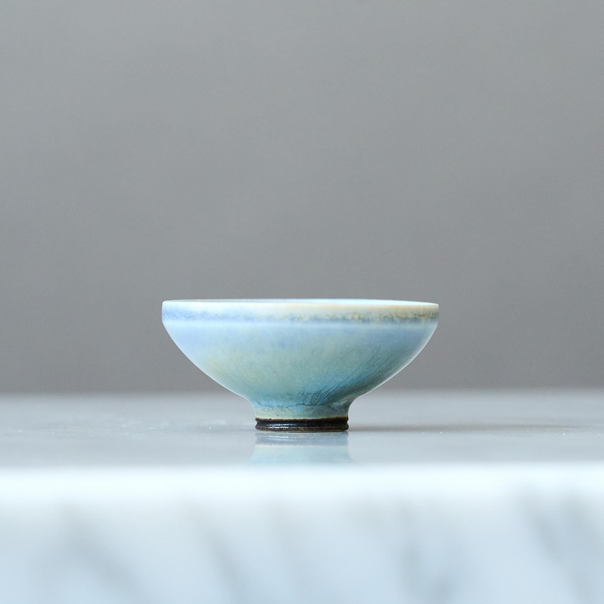 A beautiful miniature stoneware bowl with amazing light blue hare’s fur glaze.
Made by master thrower Berndt Friberg, in the artist's studio at Gustavsberg, Sweden, 1960s.

Great condition. 
Incised signature 'Friberg' and Gustavsberg studio