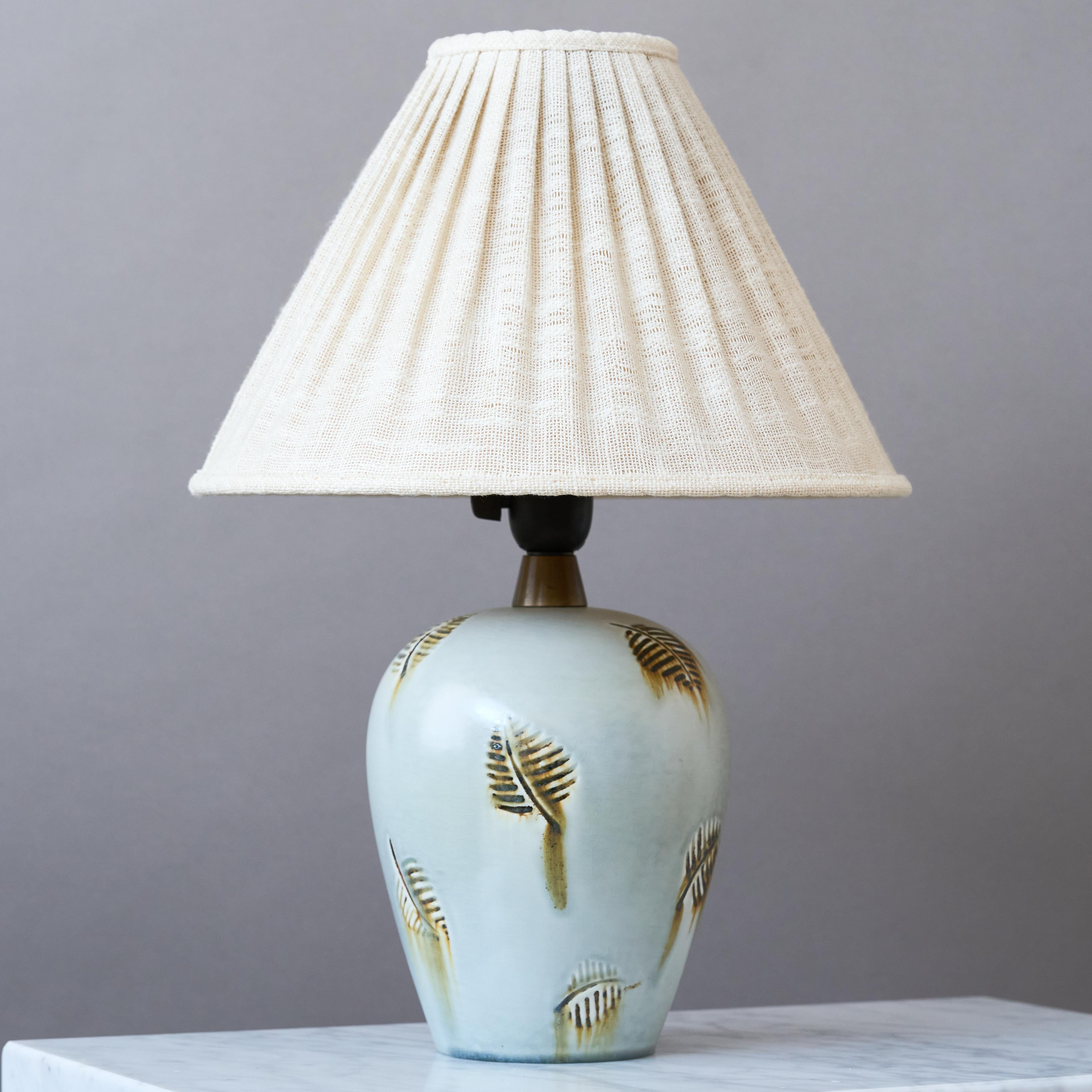 A rare and beautiful stoneware table lamp with amazing decor.
Made by Gertrud Lönegren for Rörstrand, Sweden, 1930s.

Great original condition. 
Signed 'GL', 'HANDDREJAD' and makers mark 'Rörstrand'.

Sold without lampshade.

Dimensions of the lamp
