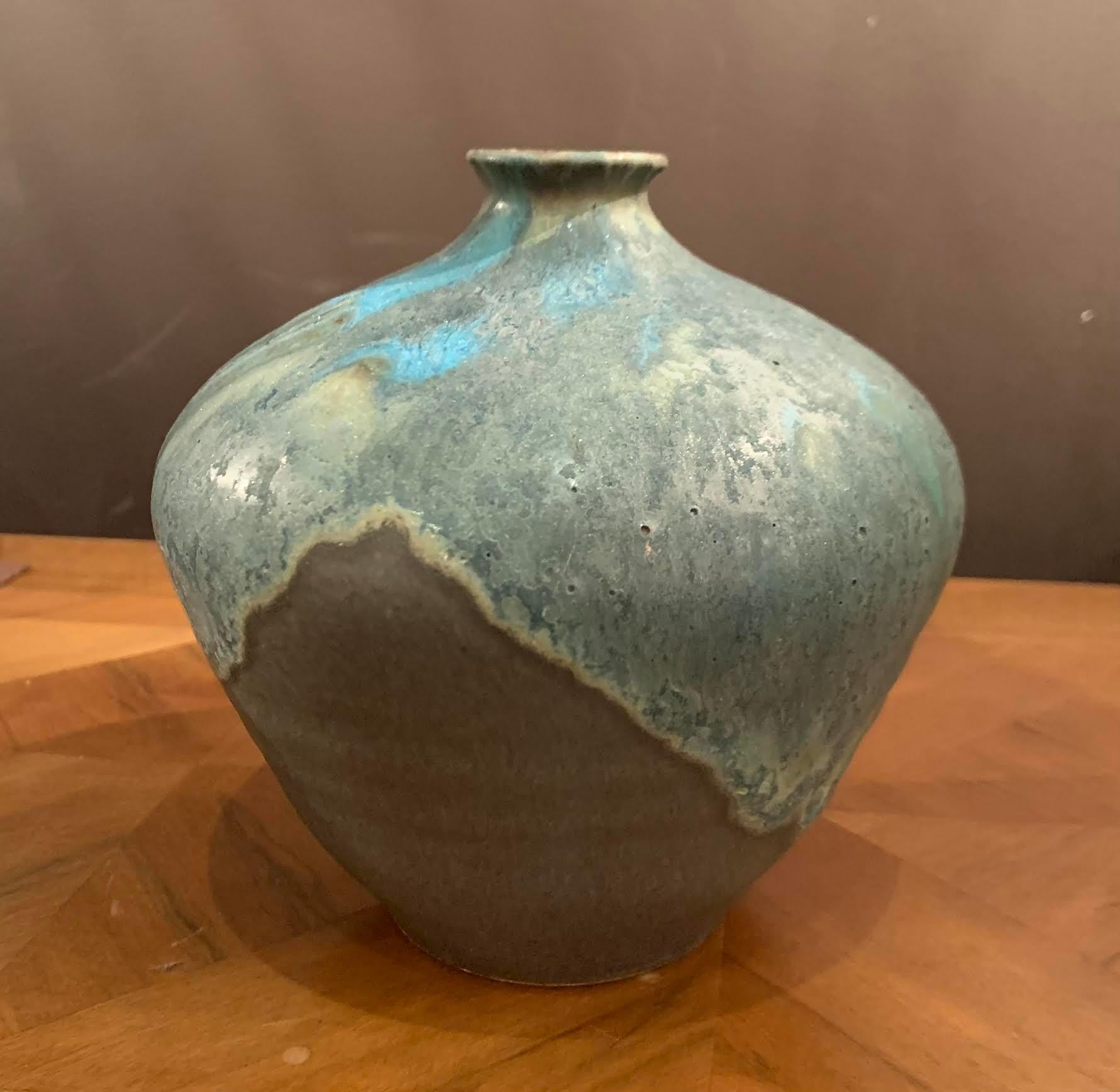 Contemporary American Ceramist Peter Speliolpoulos stoneware vase.
The matte blue glaze, paired with an agate glaze, react to create pieces with a mineral feeling, just unearthed.
One of a kind, hand thrown and glazed piece.
Signed by the