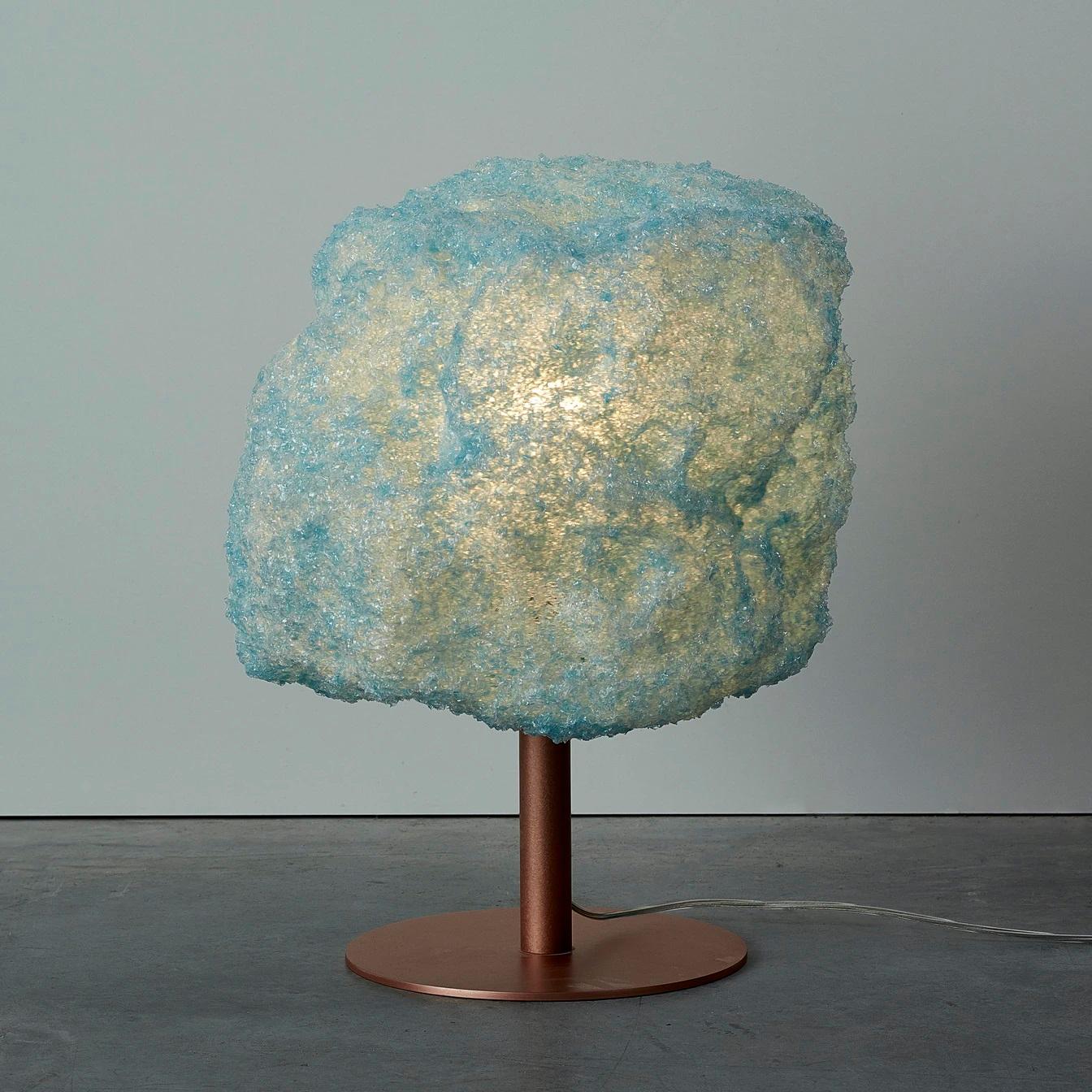 Blue storm table light copper by Johannes Hemann
Material: Polycarbonate, walnut
Dimensions: Ø 38 x H 45 cm

The Storm Series is by its concept the purest example of a process-design, where the designer seeks to set creative parameters to allow