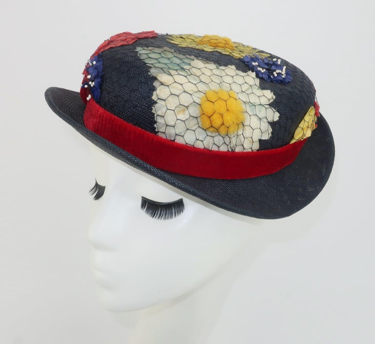 1950's blue straw hat fully decorated with silk flowers covered with netting and a ruby red velvet band.  The charming look is reminiscent of Eliza Doolittle or Mary Poppins.  Designed by Beachurst Original of New York.
CONDITION
The straw body is