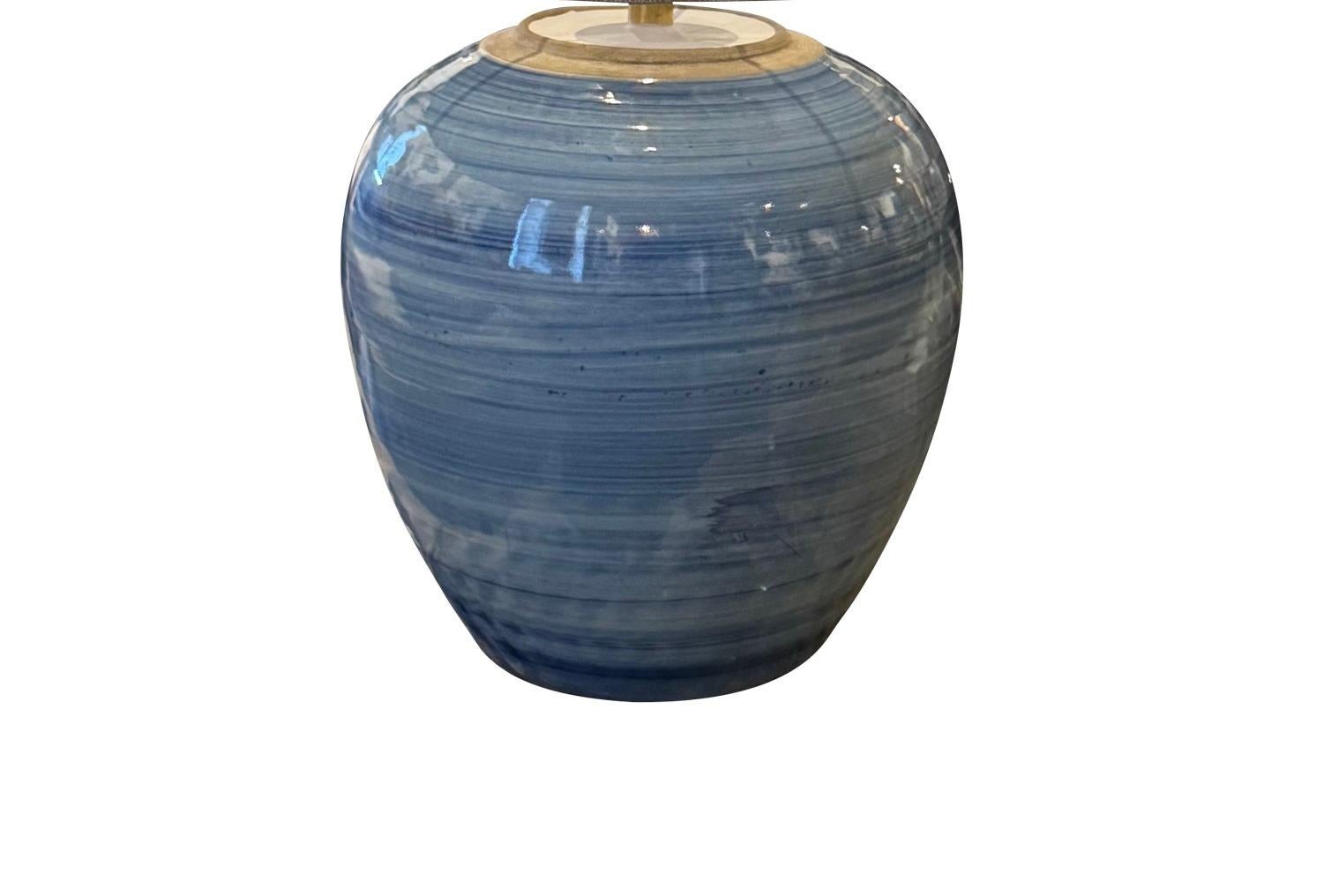 Contemporary Chinese single round shape with 
striated horizontal blue glaze.
Belgian linen shade included.
Pair also available. L1180
Base measure 10