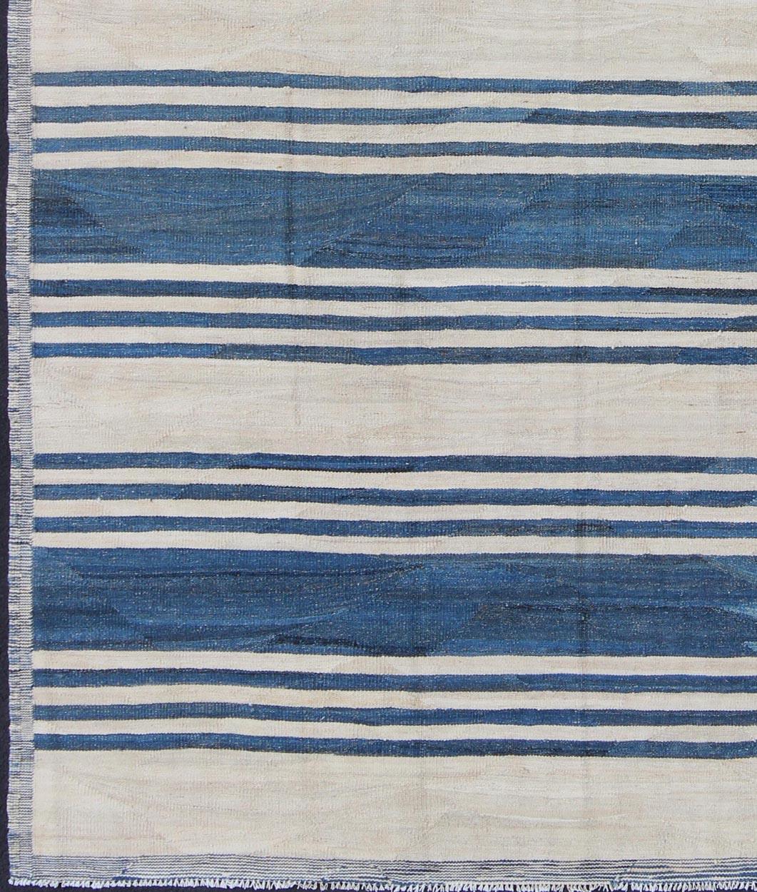 Casual flat-weave Kilim rug with blue color in Classic Stripe design, rug afg-6369, country of origin / type: Afghanistan / Kilim

This vibrant Kilim rug features a Classic stripe design, perfectly suited for casual and easy interiors, such as