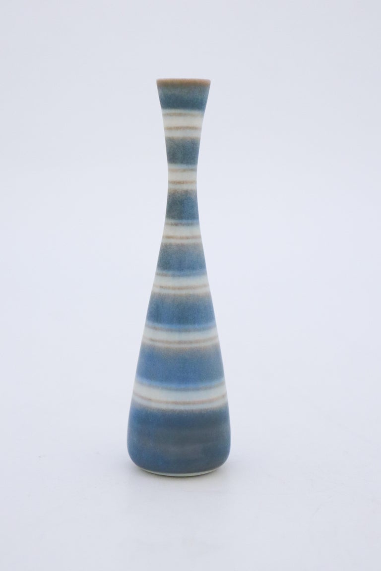A blue vase with a striped decor designed by Gunnar Nylund at Rörstrand, they are 12.5 cm (5) high and 3.5 cm (1.4
