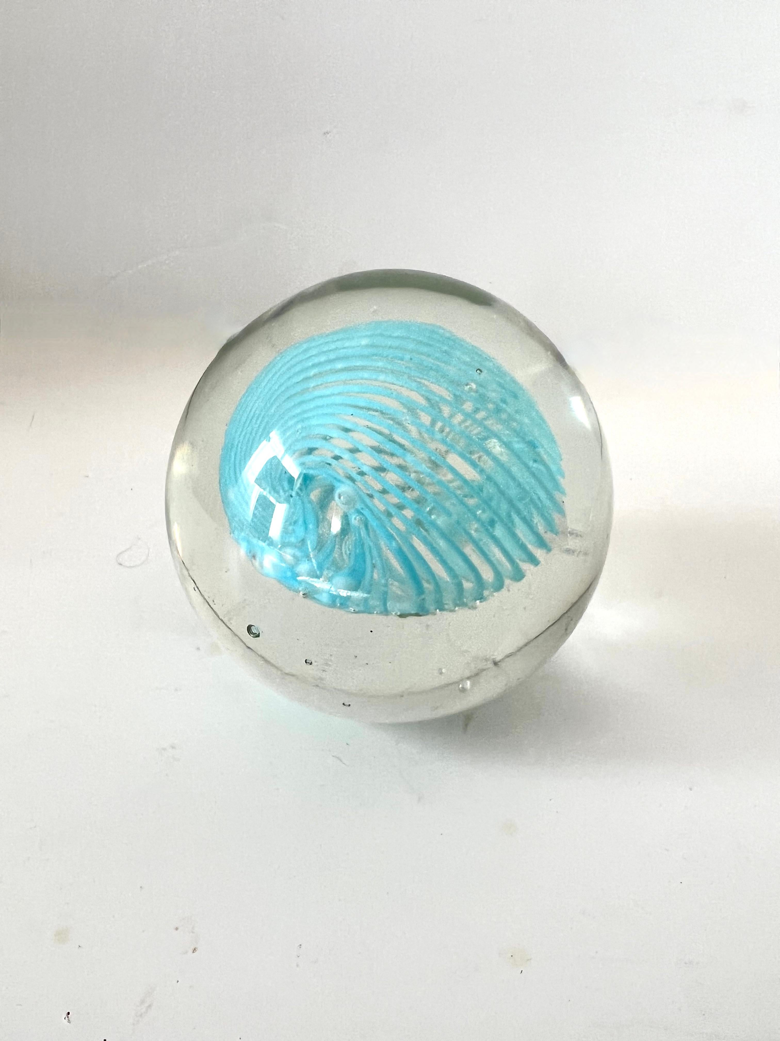  A beautiful clear glass paper weight with a Tiffany Blue Swirl of glass - the perfect size and could be a paperweight for smaller books.