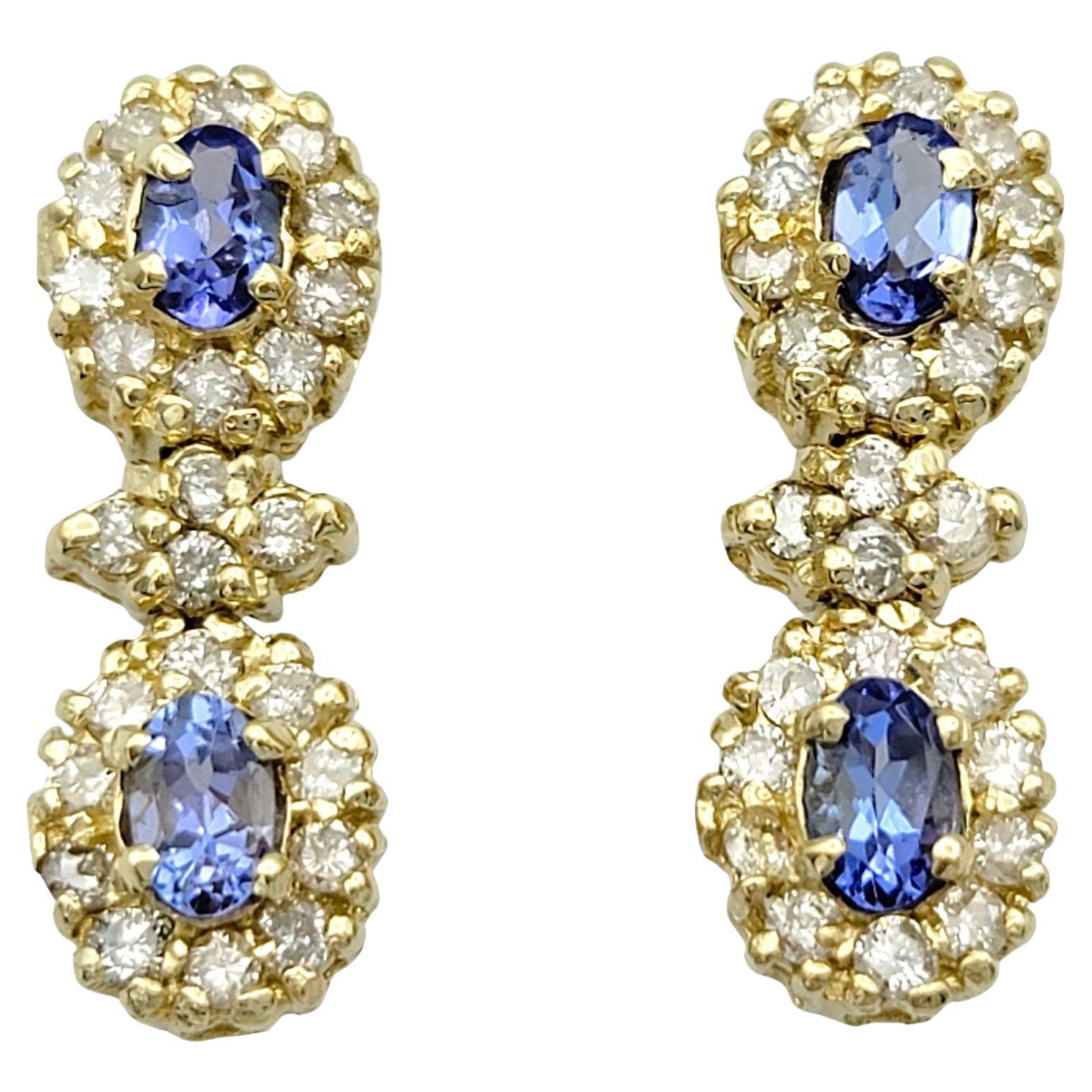 Blue Tanzanite and Diamond Halo Dangle Earrings Set in 14 Karat Yellow Gold For Sale