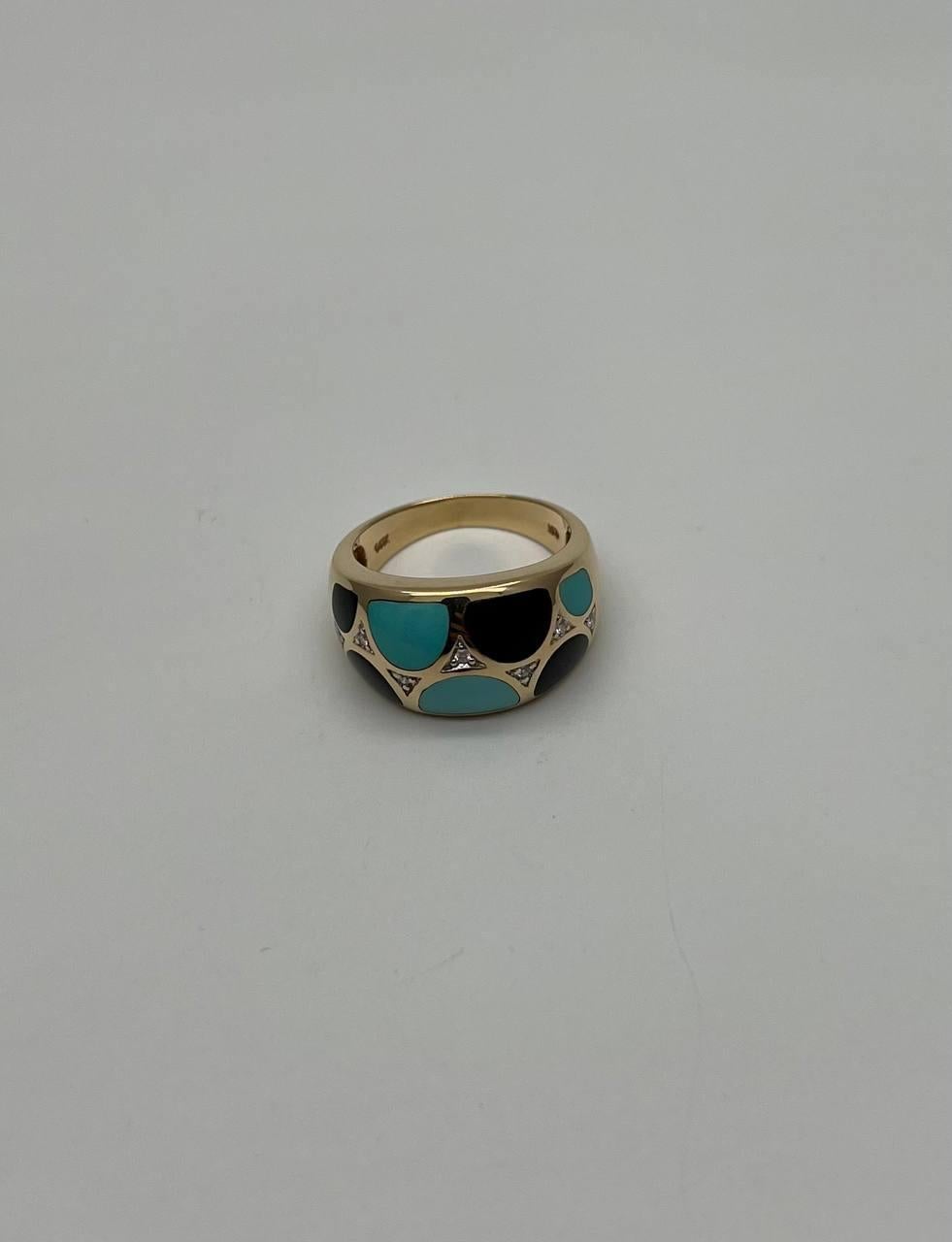 A striking ring featuring a bold design with turquoise and black onyx inlays set in a polished gold band. Intricate triangular accents add a touch of elegance. 14K Yellow Gold. 2.30 CTW Black Onyx and Blue Turquoise. 0.05 CTW Diamonds.