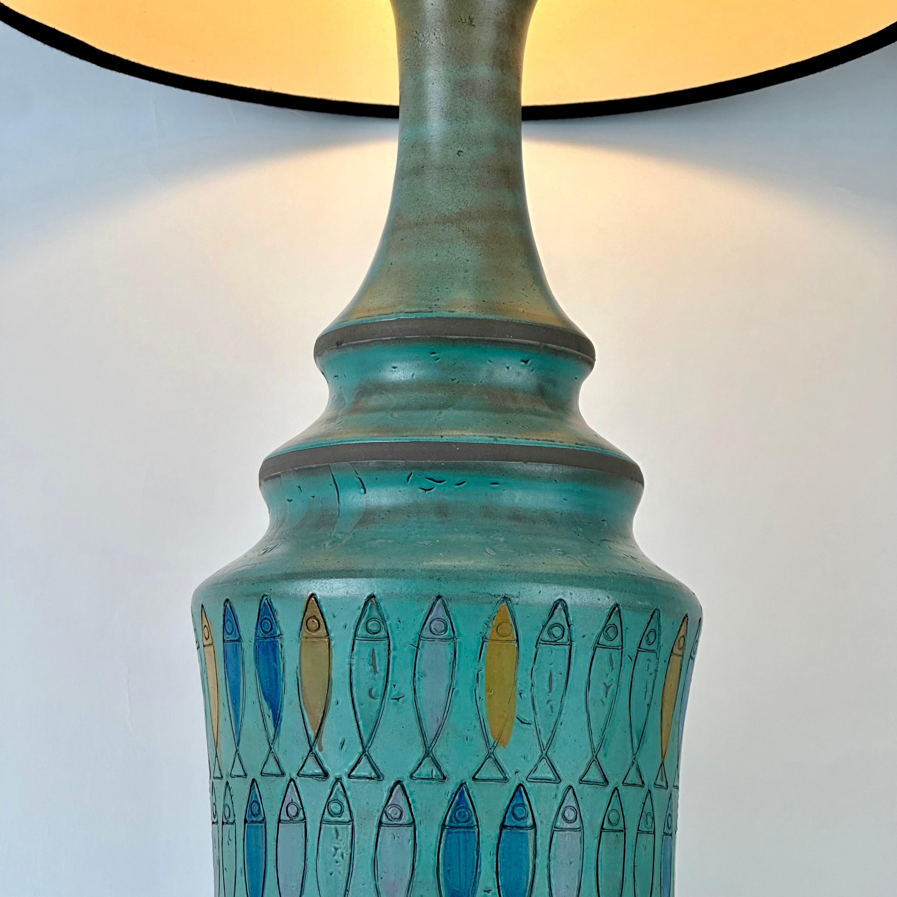 Beautiful blue enameled terracotta with engraved fish table lamp signed on the bottom with brown cotton lampshade (size: 36 diam. x 33 H cm.). Table lamp with shade height: 90 cm. One E27 light bulb.

Aldo Londi (1911-2003) was a painter, sculptor