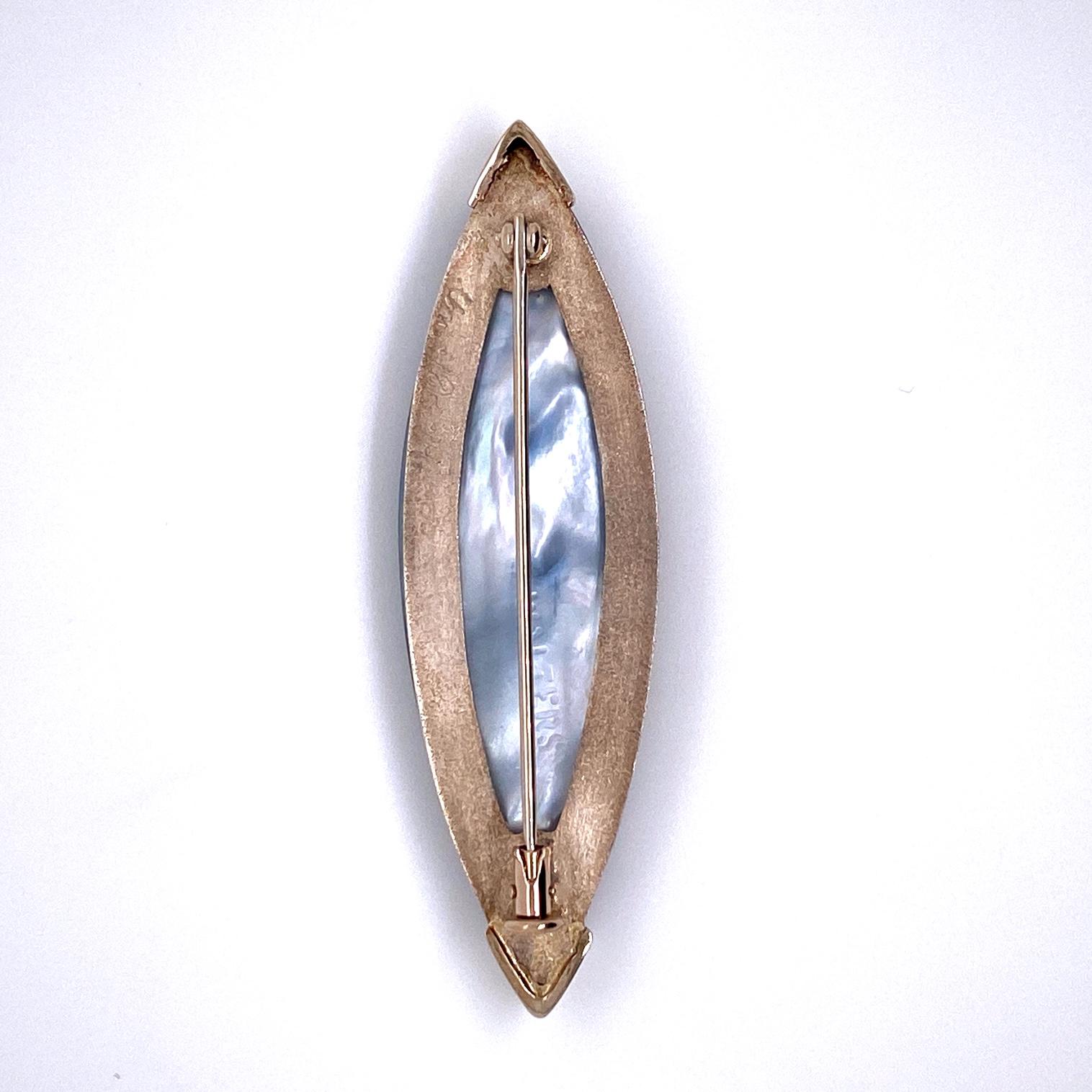 A brooch made with a Steve Walters Stone of blue tiger eye, opal, quartz, and titanium, set in sterling silver. This brooch was made and designed by llyn strong.