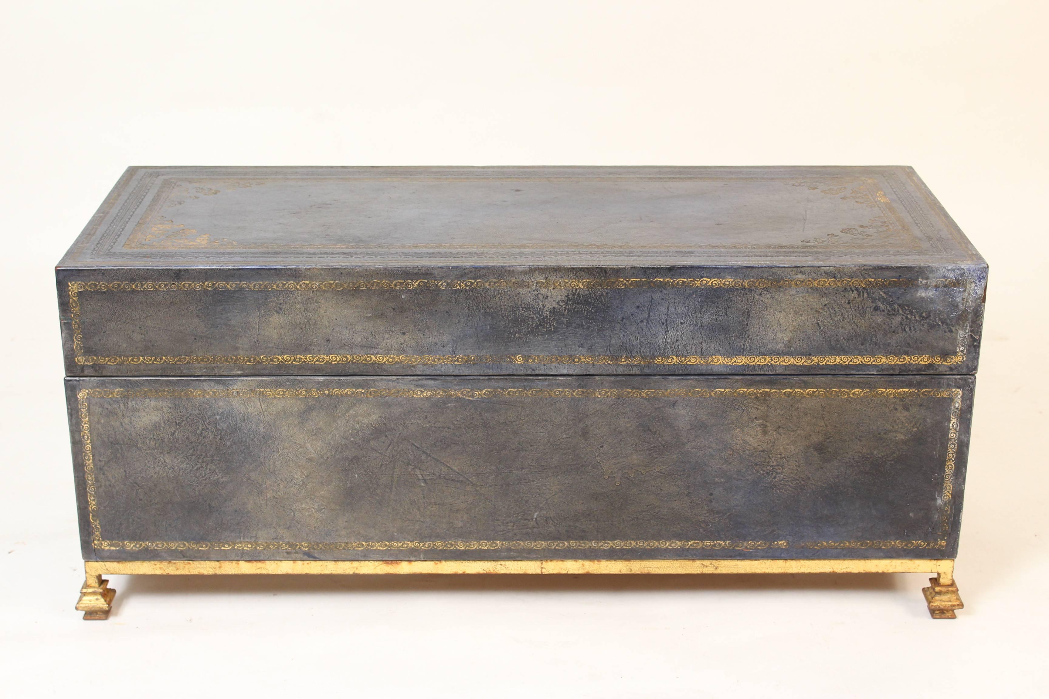 Blue leather trunk / coffee table with gilt tooling on a gilt metal base, late 20th century.