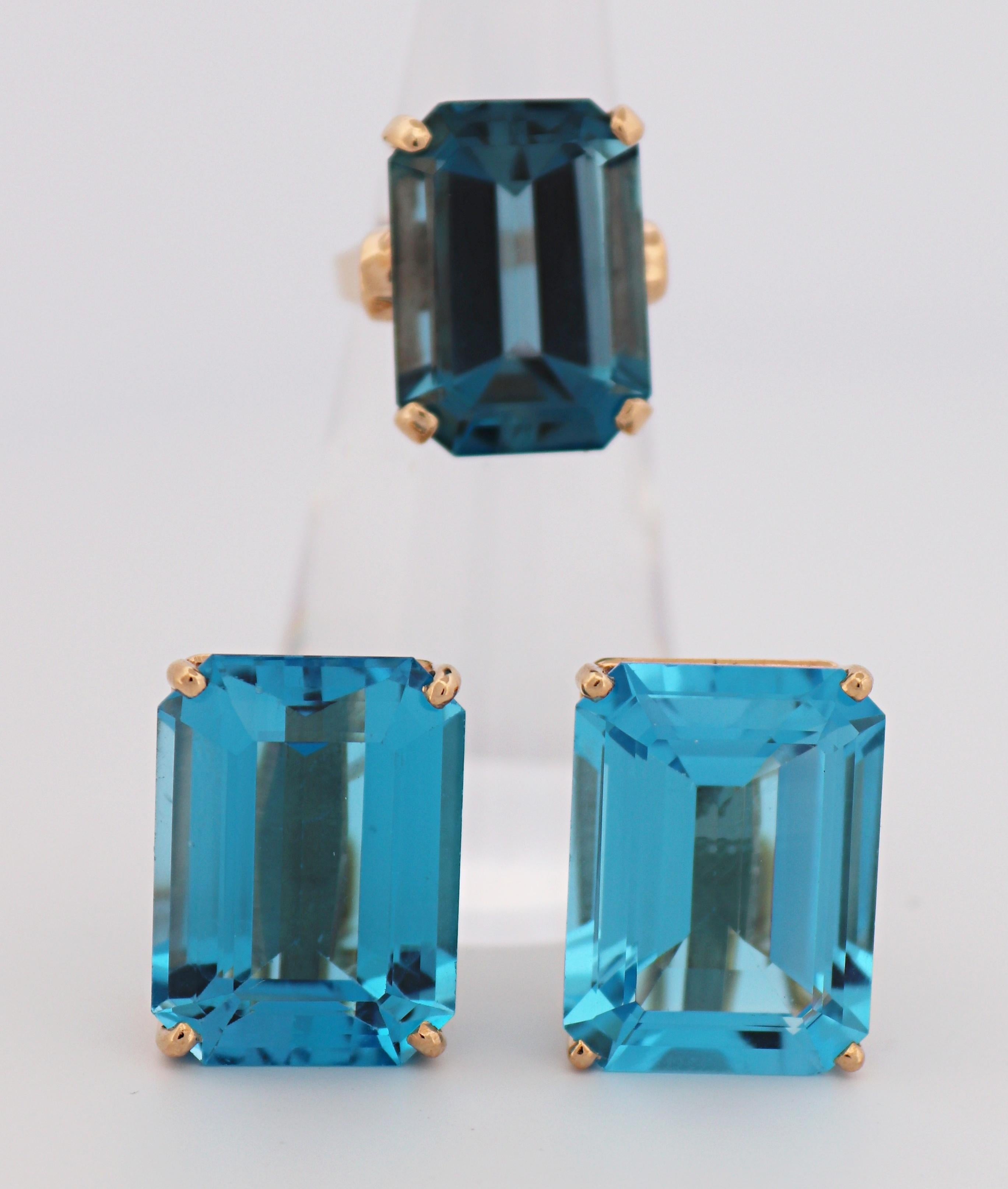 Composed one ring featuring (1) emerald-cut blue topaz, 16.70 cts., set in a 14k yellow gold mounting, 17.8 X 15.2 tapering to 1.7 mm, size 4.5, Gross weight 7.23 grams; together with a pair of matching earrings, featuring (2) emerald-cut blue