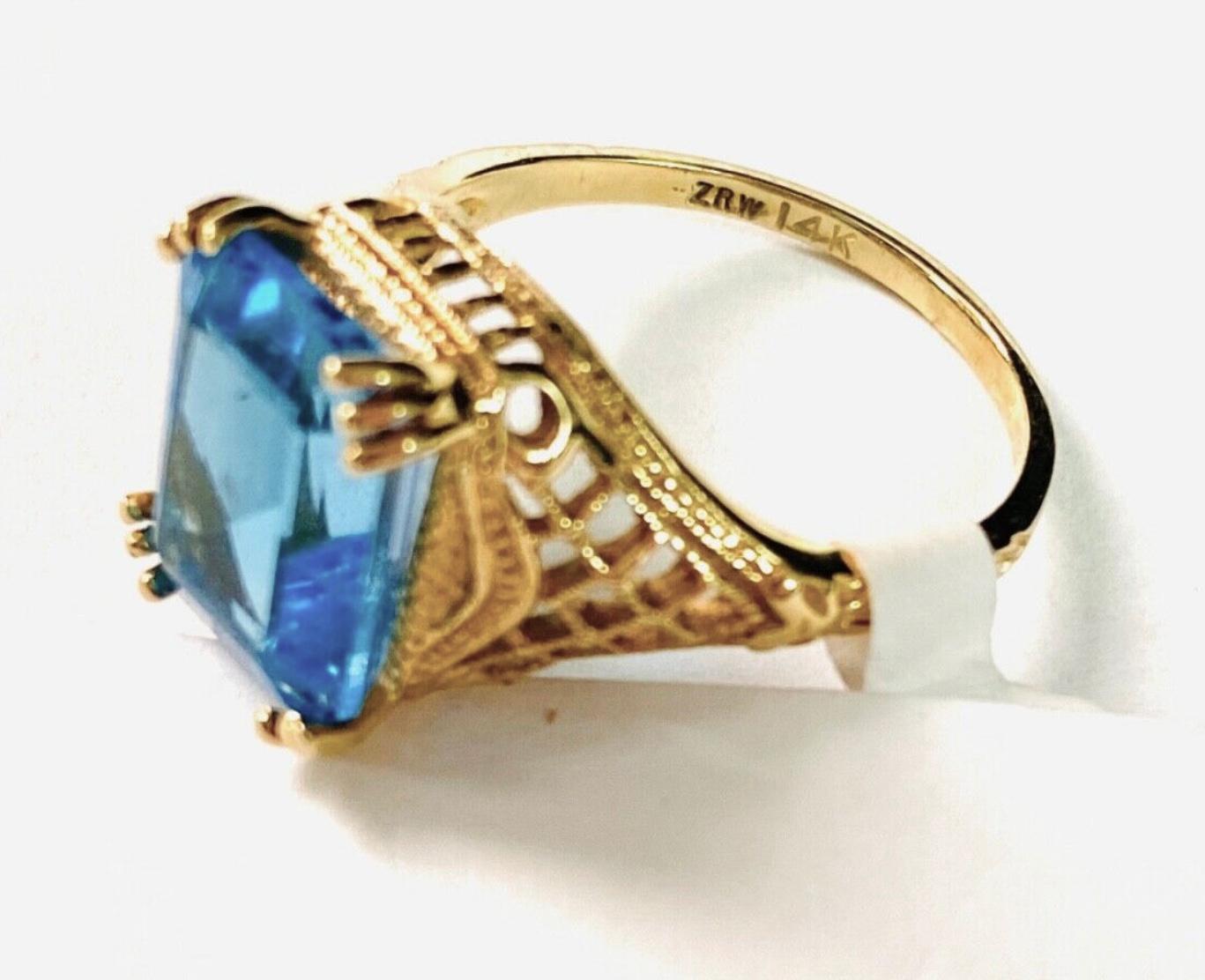 14k yellow gold Blue Topaz ring, 4.11 Grams TW. The dimensions of the approximately 11.5 mm x 8.5 mm.
Marked 14k. Approximate size 6.5