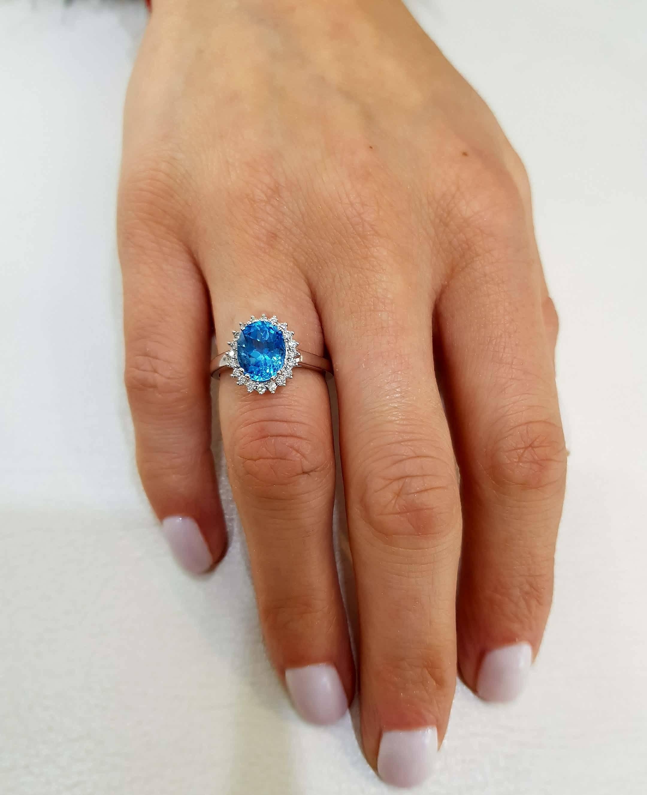 Modern Blue Topaz 2.20 Carat Oval 0.20 Carat Round Diamond White Gold Halo Ring For Sale