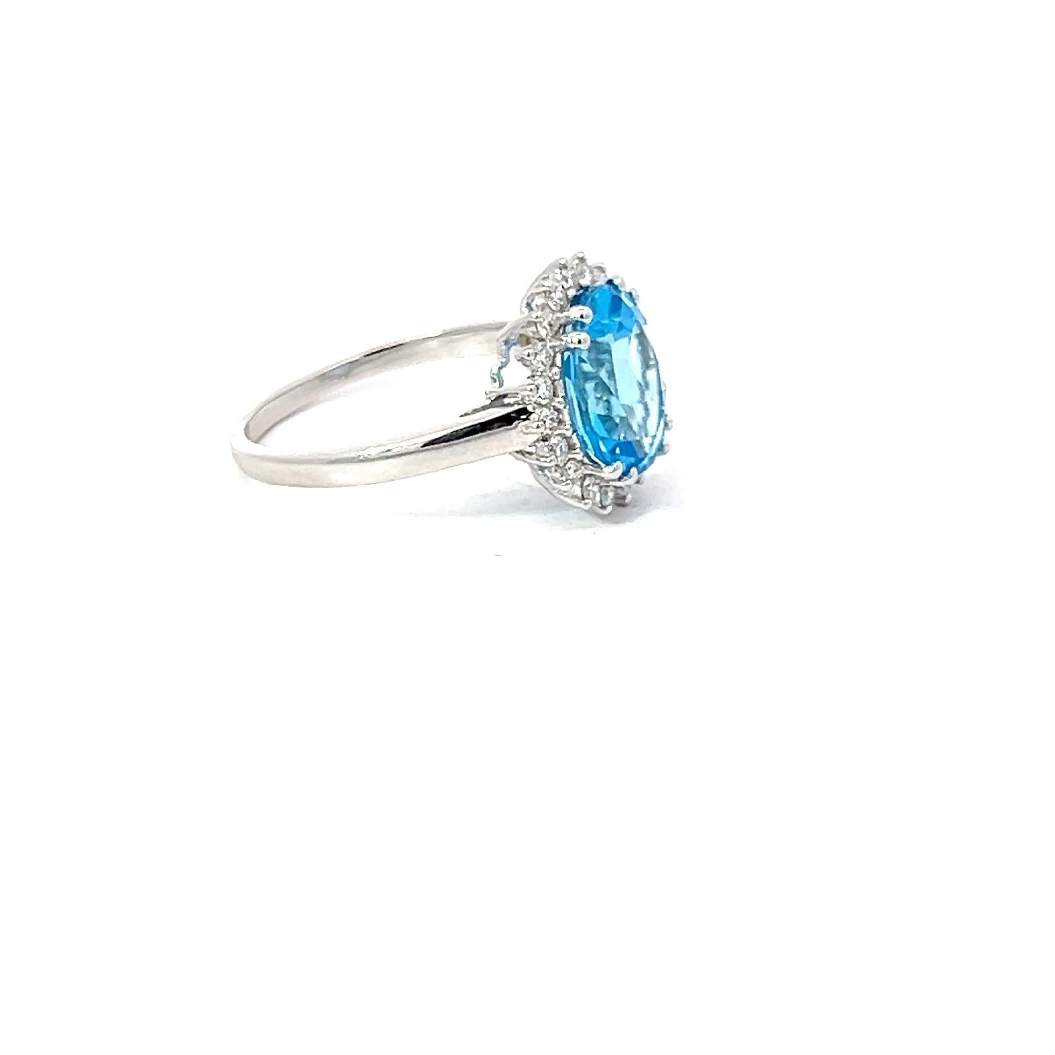 Women's Blue Topaz 3.13 Carat Oval 0.24 Carat Round Diamond 18 KT White Gold Halo Ring For Sale