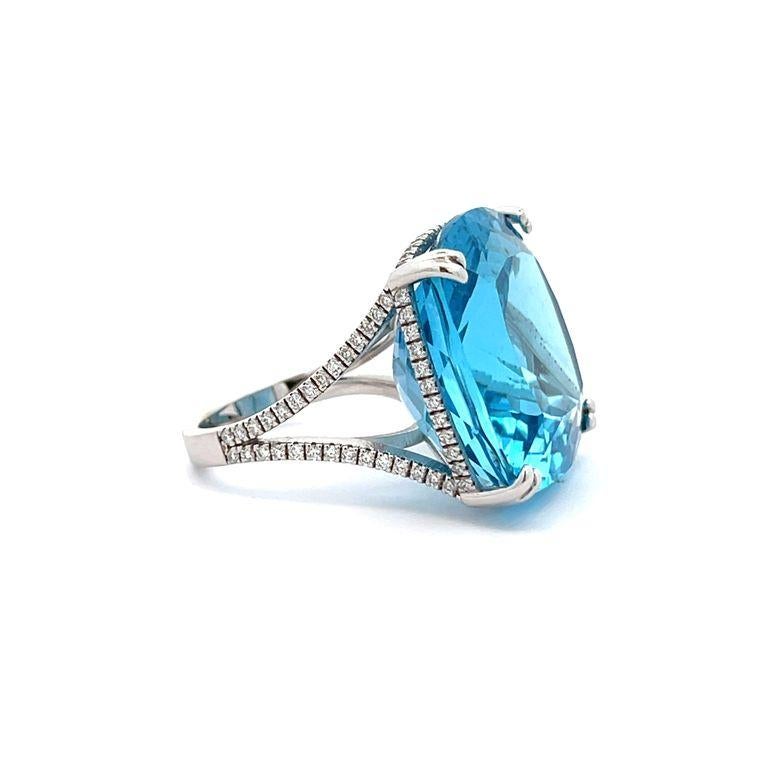 Our cocktail ring will undoubtedly captivate your heart with its stunning blue topaz gemstone that exudes beautiful color in every movement. The centerpiece of this magnificent ring features a remarkable 52.30-carat blue topaz that is elegantly