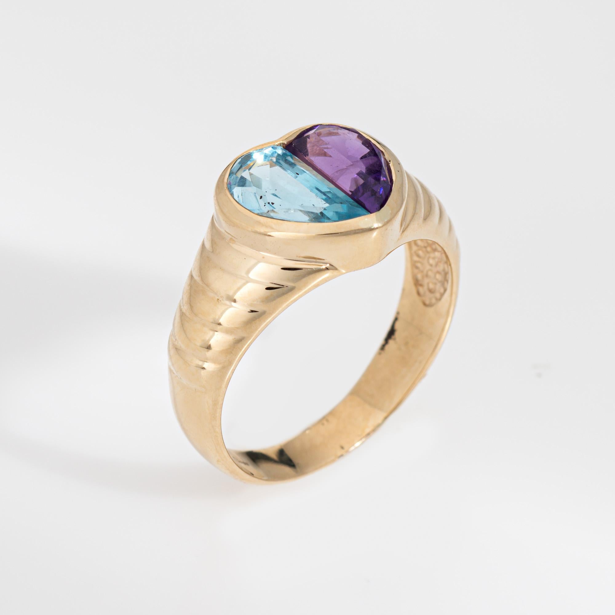Stylish vintage blue topaz & amethyst heart ring crafted in 14 karat yellow gold. 

Amethyst & blue topaz each measure 8mm x 4mm. The stones are in very good condition and free of cracks or chips. 

Faceted amethyst and blue topaz halves join