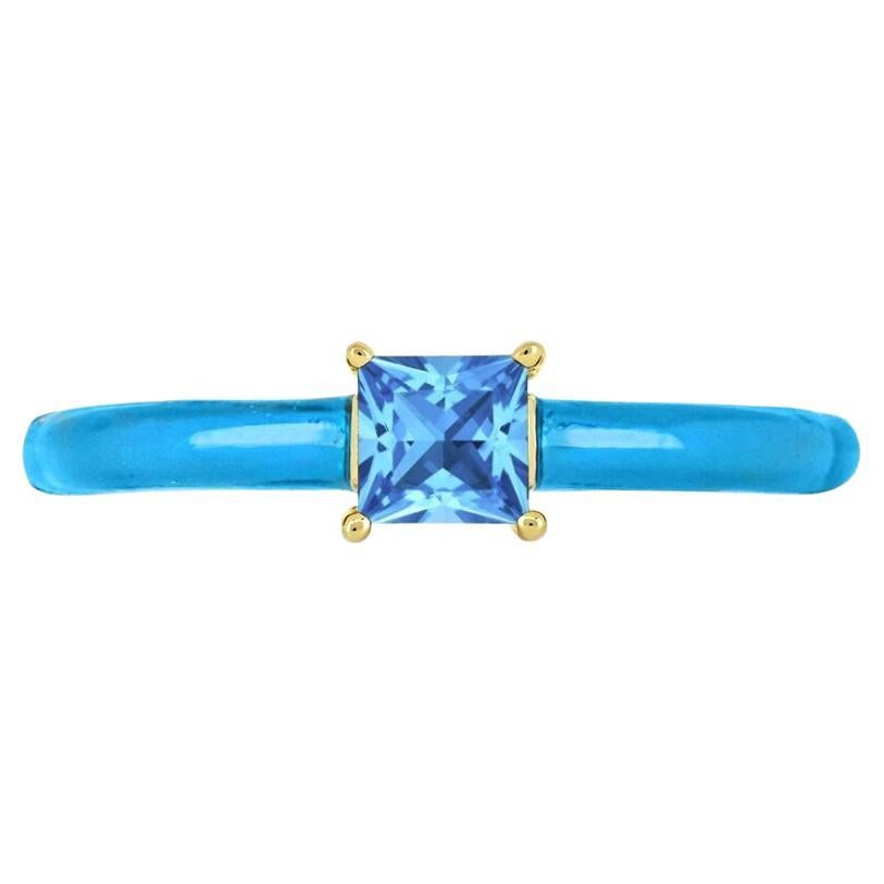 This elegant ring features one square-cut Swiss blue topaz prong sets between blue enamel shank on top of a slim band ring in 14K yellow gold over sterling silver. 

Metal: 14K Yellow Gold over Sterling Silver
Gemstone:
Swiss Blue Topaz: Square-Cut