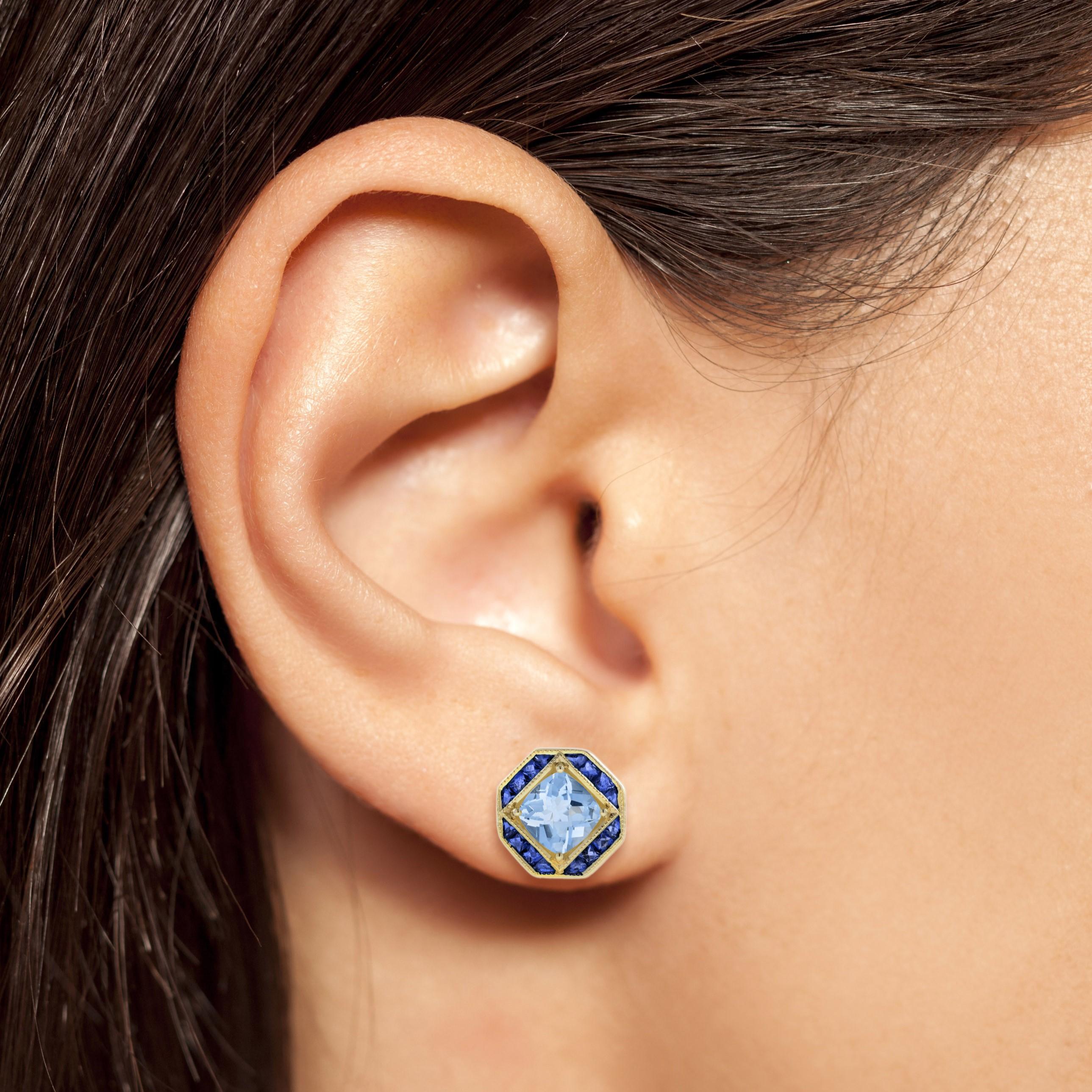 A spectacular pair of blue topaz and blue sapphires stud earrings featuring total of 4 carat blue topaz and French cut blue sapphires secured in a statement bezel yellow gold setting. These simple yet classy earrings are an ideal gift for the one