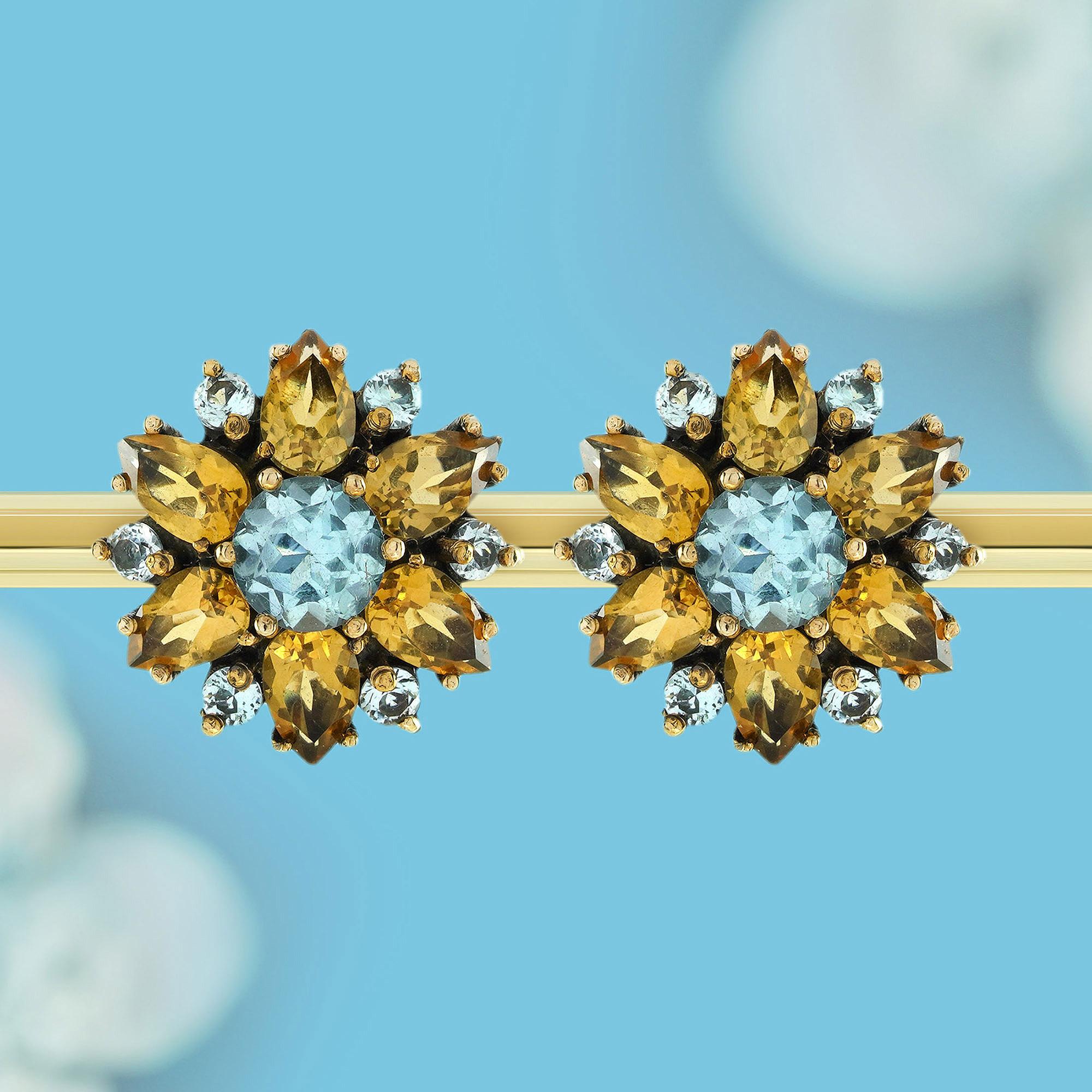 Zeitlose Eleganz mit diesen floralen Ohrsteckern im Vintage-Stil aus massivem 9-karätigem Gold. Mit den bezaubernden Farbtönen von natürlichem Blautopas und Citrin verleihen diese Ohrringe jedem Outfit einen strahlenden Touch. Das zarte florale