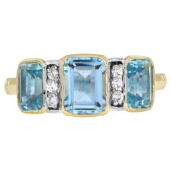 Anillo de tres piedras estilo Art Déco de oro amarillo de 14 quilates con topacio azul y diamantes