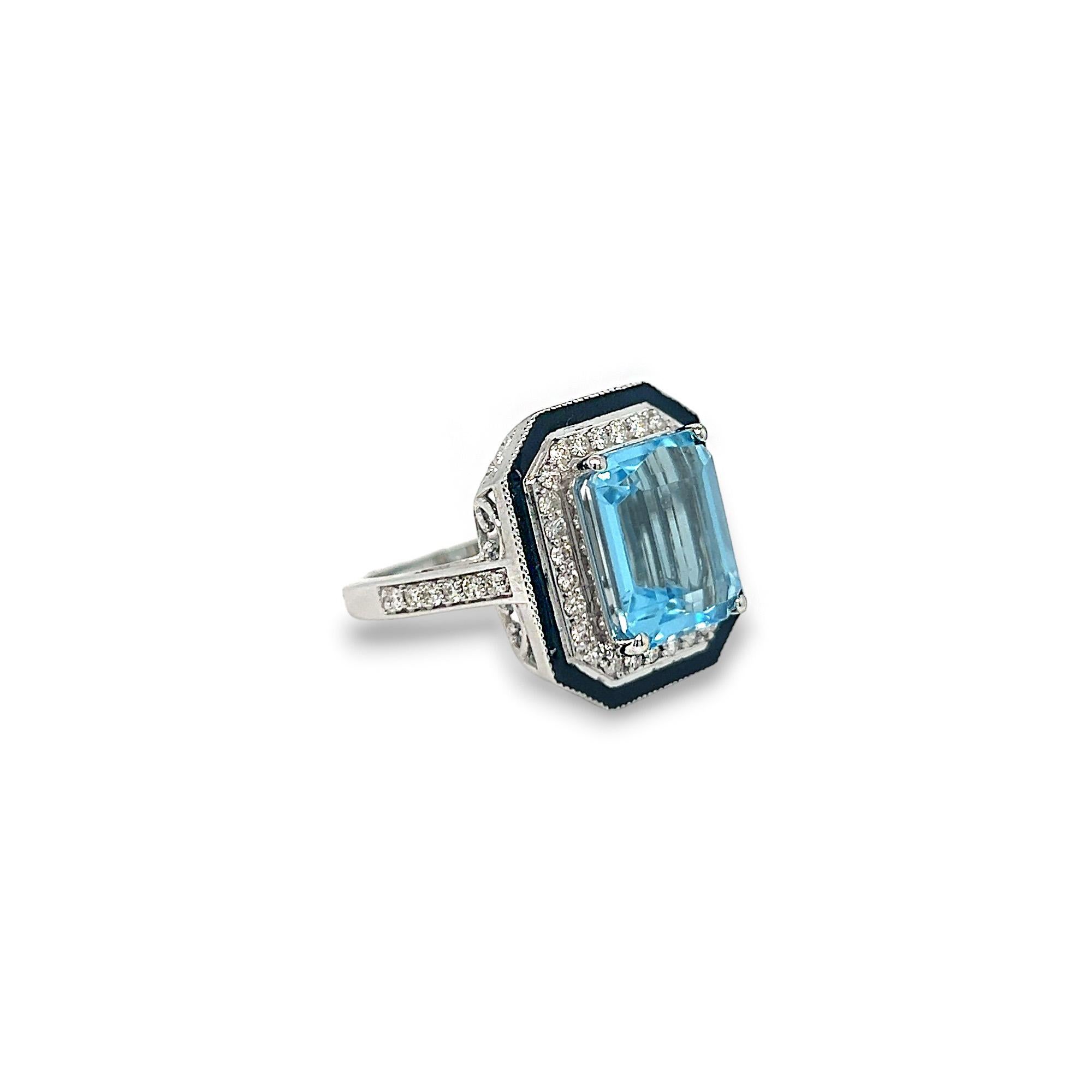 This gorgeous blue topaz and diamond black enamel ring features a 7.50 ct emerald cut blue topaz center stone. The ring also has stunning rounding diamonds weighing 0.48 total cts and of G/H/I color and VS clarity. Set in 14k white gold, this ring
