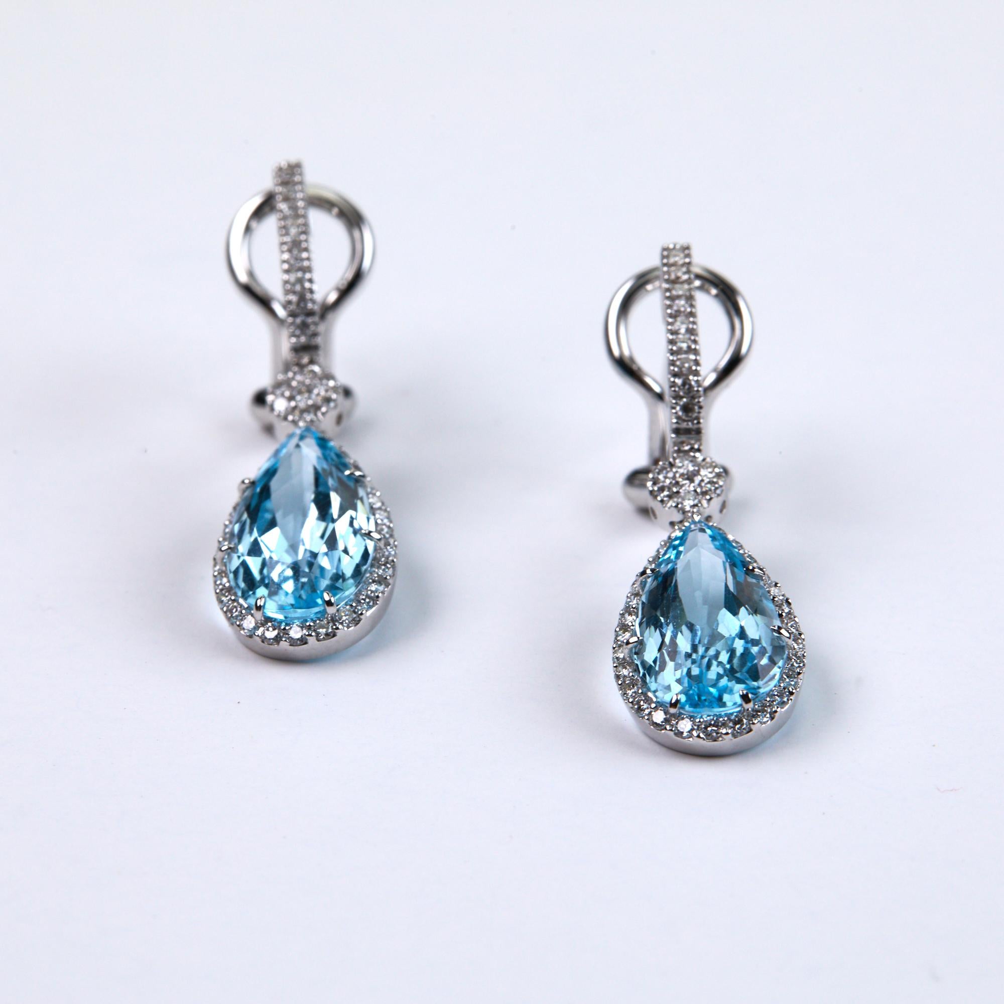 Blue Topaz And Diamond Dangle Earrings beautifully worn for day or evening.  Two Pear Shaped Blue Topaz stones weighing 8.94 carats and an additional .67 carats of brilliant round cut diamonds make these exceptional drop earrings.  The diamonds make