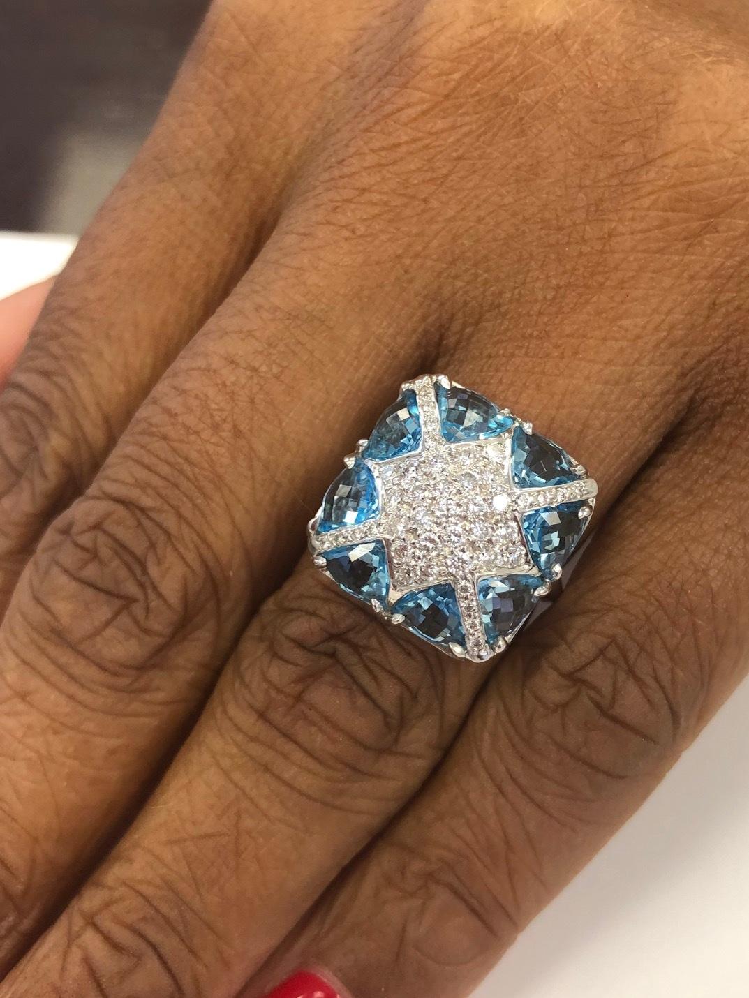 This is a very delicate design with all specially cut Blue Topaz. The ring is made in 18 Kt White Gold, set with 41 diamonds 0.60 carat and 8 custom cut trillion Blue Topaz 5.10 carats. Also available with Topaz trillions.
The ring finger size is