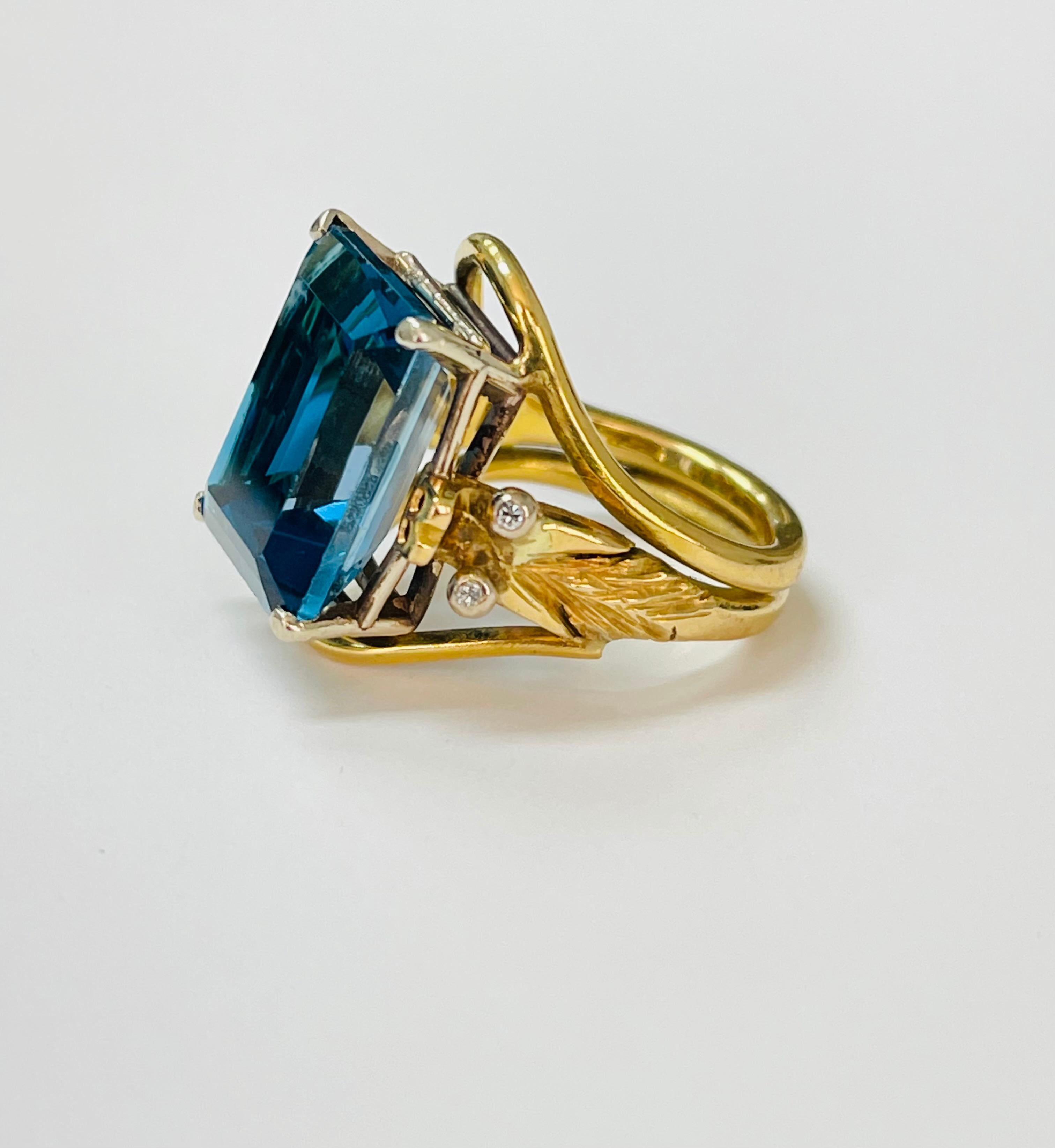 Blue topaz and diamond engagement ring handcrafted in yellow gold. 
The details are as follows : 
Blue topaz weight : 13 carats approx 
Measurements : 16.2mm by 12.4 mm 
Ring size : 5 3/4 

