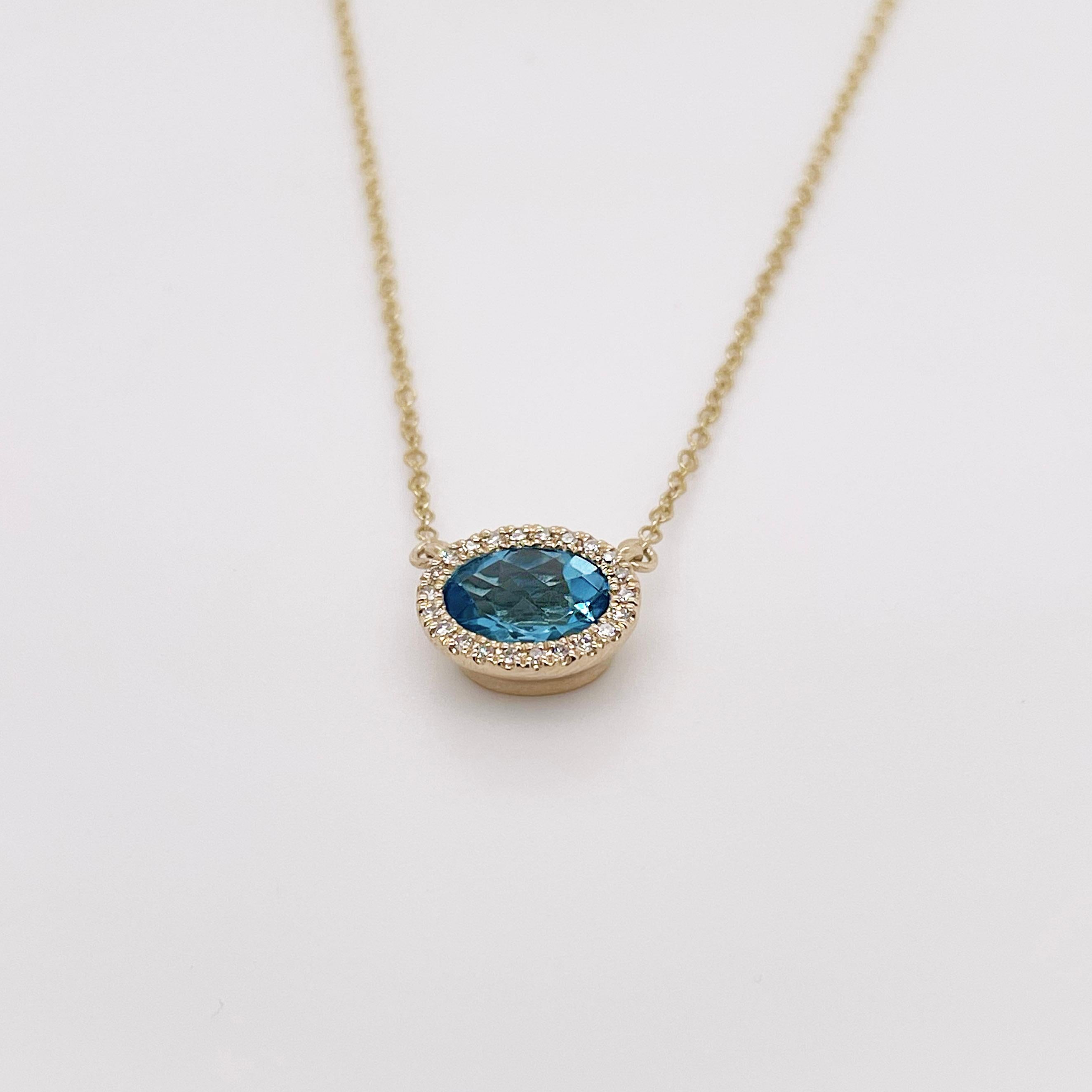 Blue topaz and diamond pendant, made in solid 14 karat yellow gold. This pendant is made with genuine, natural diamonds and a genuine blue topaz gemstone. The blue topaz gemstone is vivid and vibrant and pairs perfectly with other necklaces! 

The