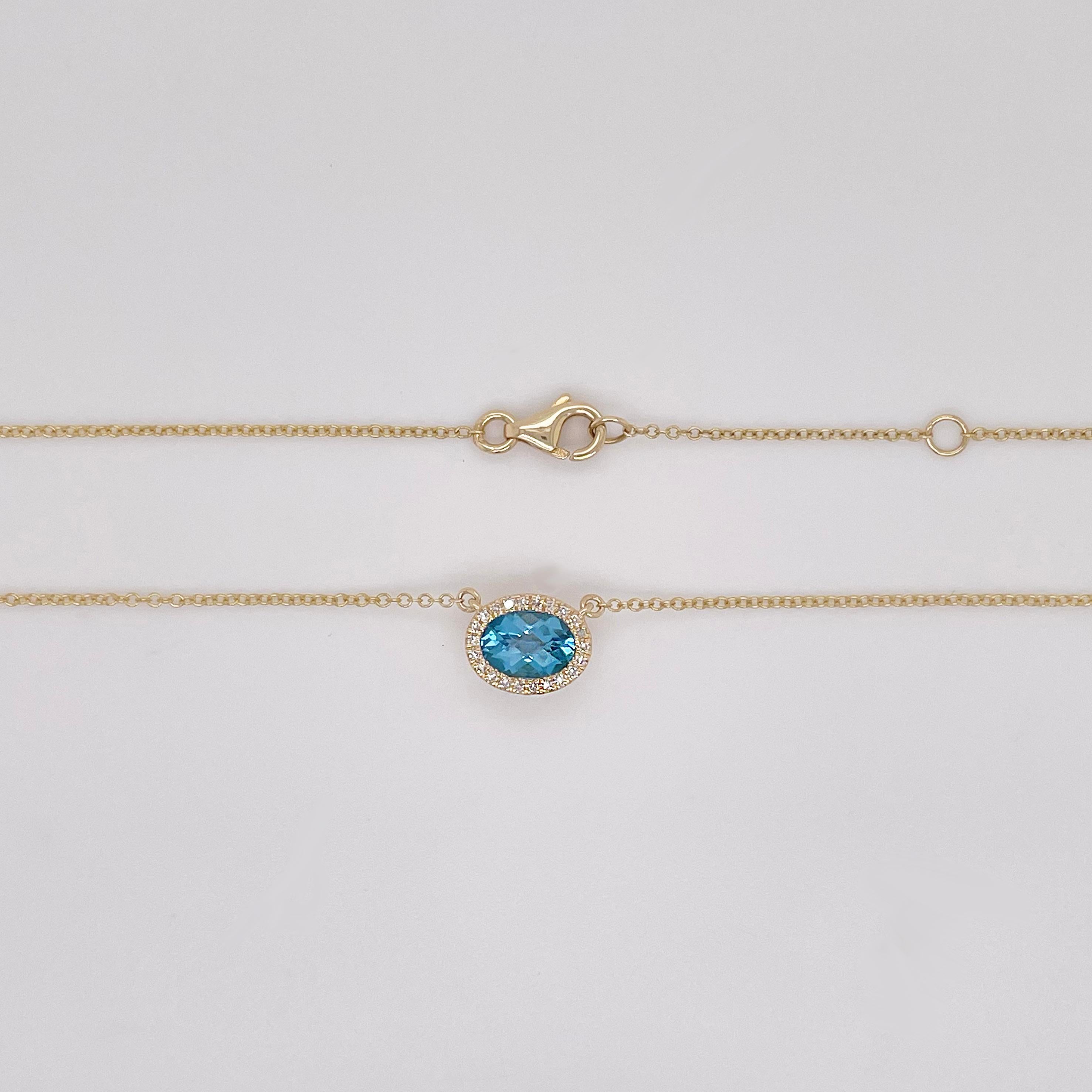 Oval Cut Blue Topaz and Diamond Halo Pendant Necklace in 14K Yellow Gold .91 Carats For Sale