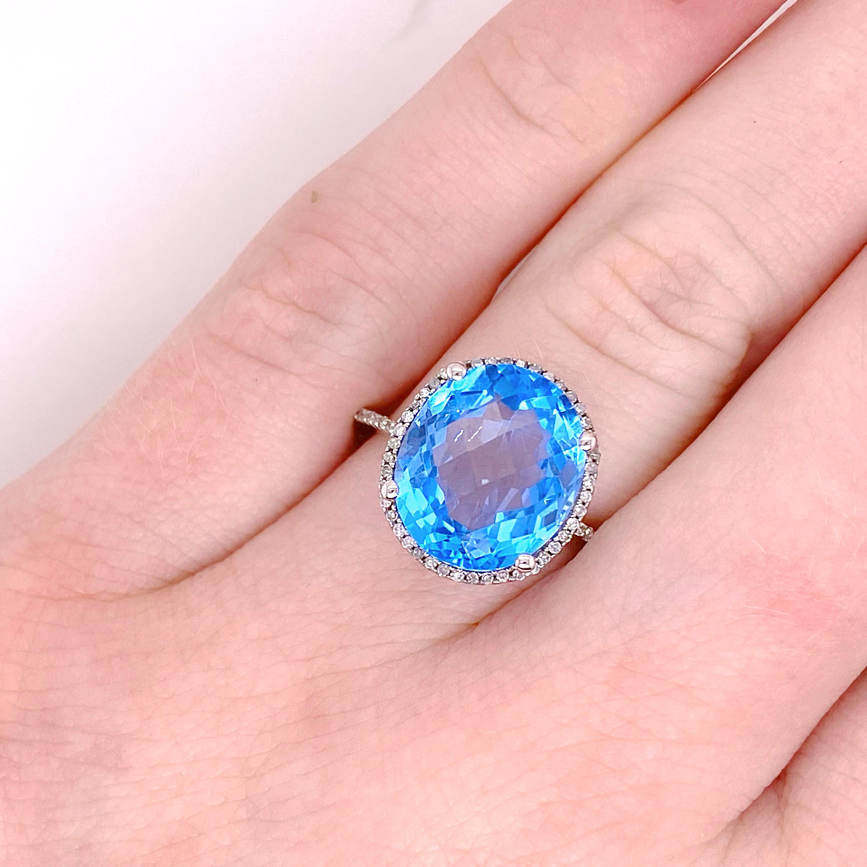 The gorgeous blue topaz and diamond ring has a very unique diamond prong settings. The blue topaz has a diamond halo around it as well as on the basket and prongs. This ring is covered in diamonds! This would make a great addition to any fine