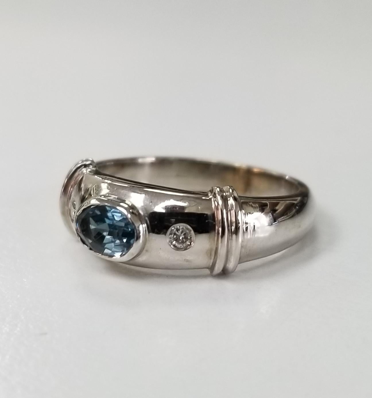 14k white gold Blue Topaz and diamond ring, containing 1 oval blue topaz weighing .55pts. and 2 round diamonds burnished weighing .04pts.  This ring is a size 5.5 but we will size to fit for free.
