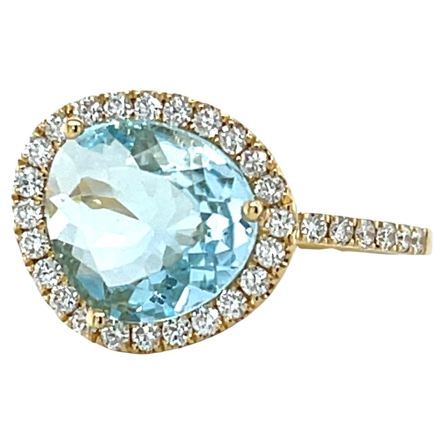 Bague en or jaune 18k avec topaze bleue et diamant