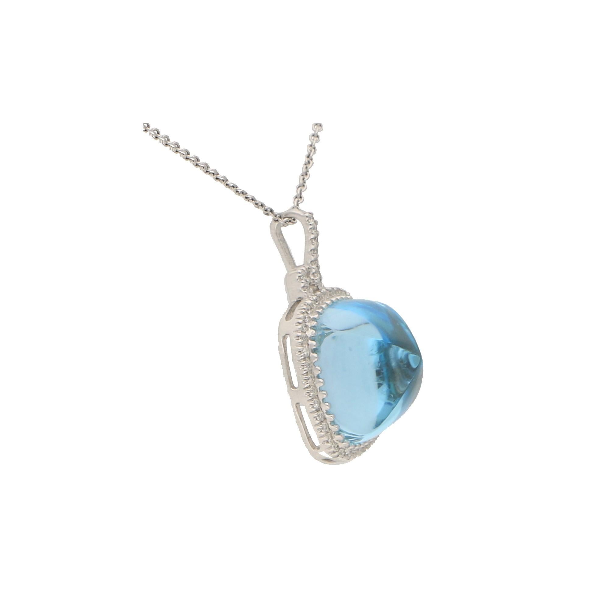 A vibrant blue topaz and diamond pendant necklace set in 18k white gold.

The pendant is centrally set with an astounding 16.15 carat sugar loaf cabochon blue topaz. This topaz has a gorgeous sky blue colour to it and this is enhanced further by a