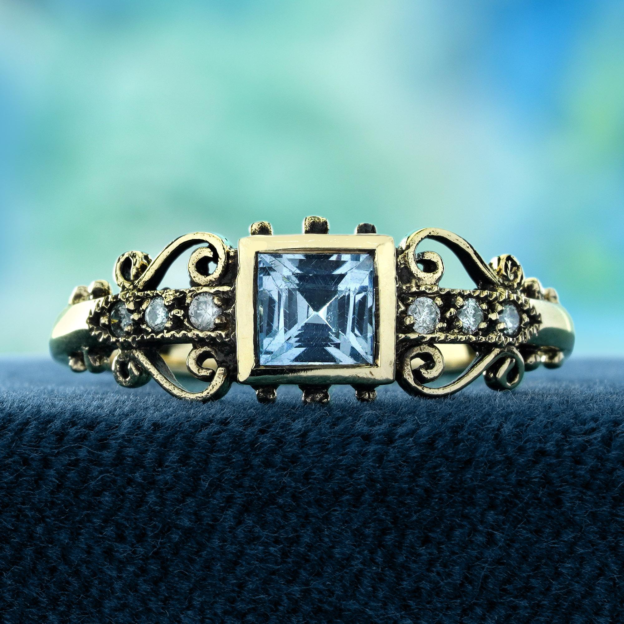 A stunning bezel-set square blue topaz at its center, radiating a deep, vibrant blue. The shoulders of the ring are adorned with intricate filigree detailing, beautifully enhanced by sparkling diamonds that add an extra layer of brilliance. The