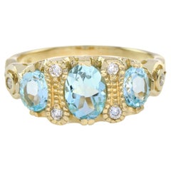 Blue Topaz and Diamond Vintage Style Three Stone Ring in 9K Yellow Gold