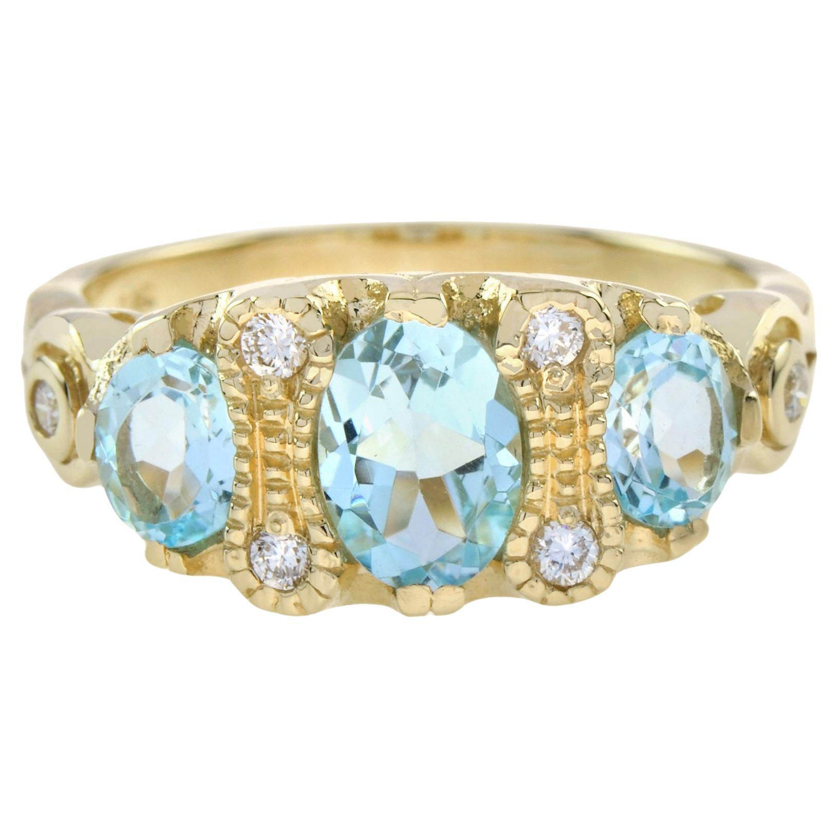 Im Angebot: Dreisteinring aus 9 Karat Gelbgold mit blauem Topas und Diamant im Vintage-Stil ()