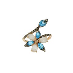 Ring aus Roségold mit blauem Topas und Mondstein Blume