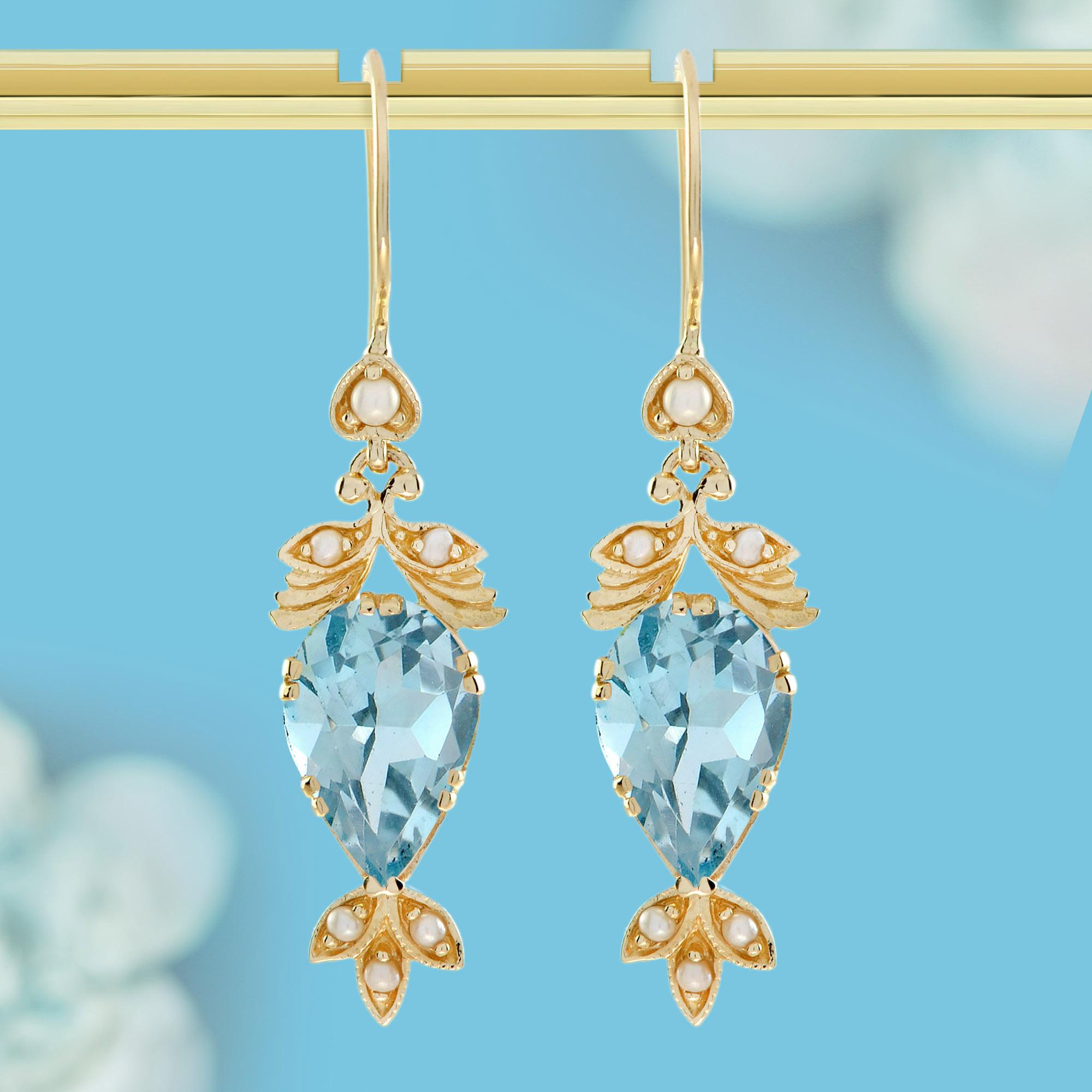 Estos Pendientes Colgantes de Topacio Azul Natural y Perla Estilo Vintage presentan lustrosas perlas tanto en la parte superior como en la inferior, con un impresionante topacio azul en forma de pera como piedra principal en el centro. El diseño