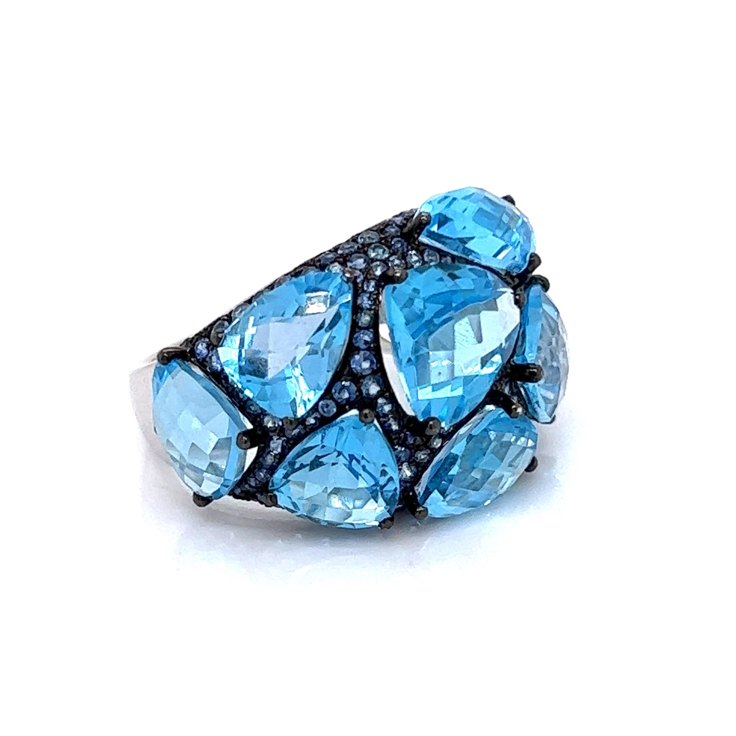 Vibrant and unique, December Birthdays and blue topaz collectors will enjoy this vintage ring.  An irresistible bold design with 9.1 grams of 18 K white gold and contrasting black rhodium.  15.21 cttw of blue topaz and 1.15 cttw blue sapphire. This