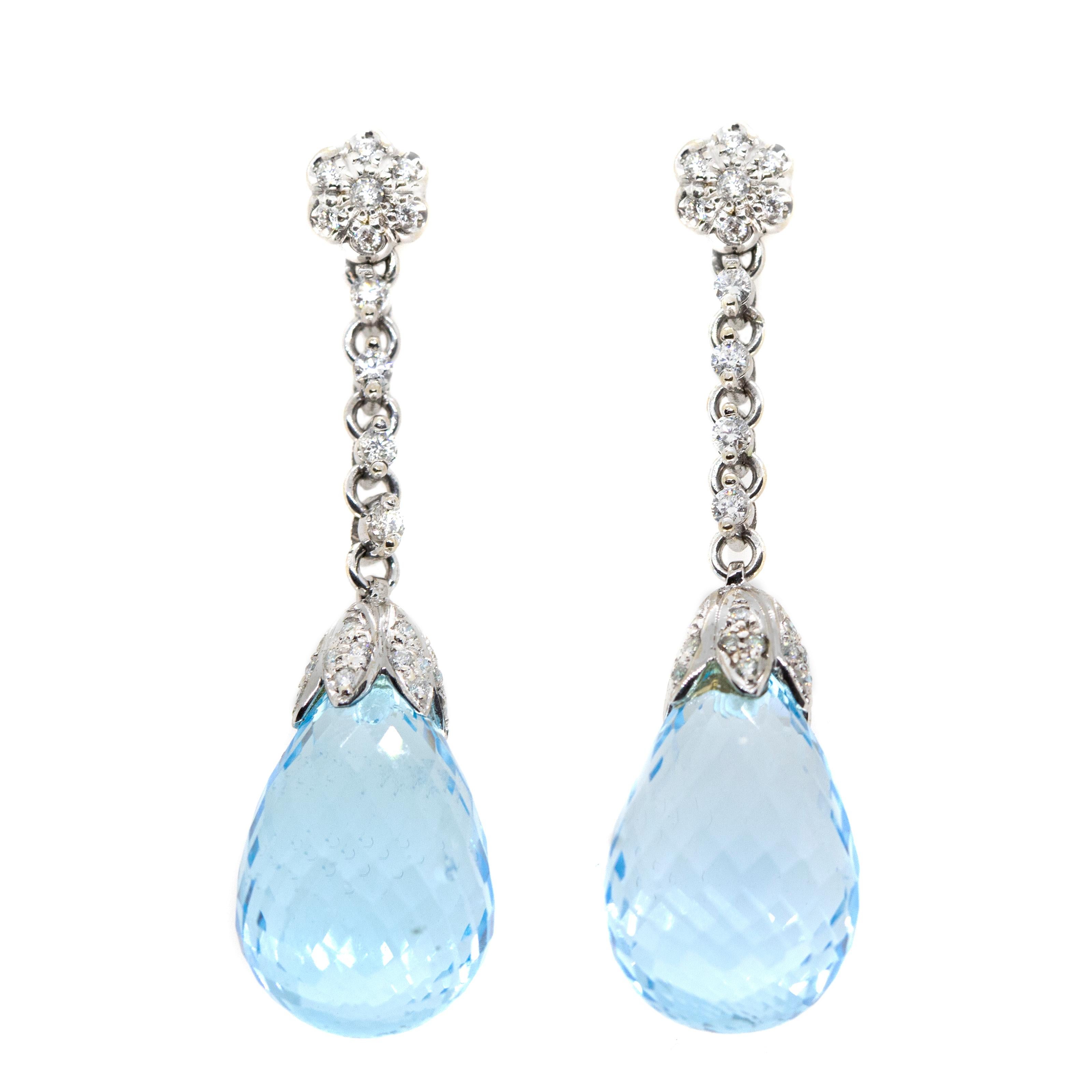 These delicate earrings, masterfully created by hand from 18-karat white gold each feature a stunning blue topaz and white diamonds, bezel- and pavé-set. The topaz total 45.50-carats.

This is a delightful pair of post-back earrings; they measure