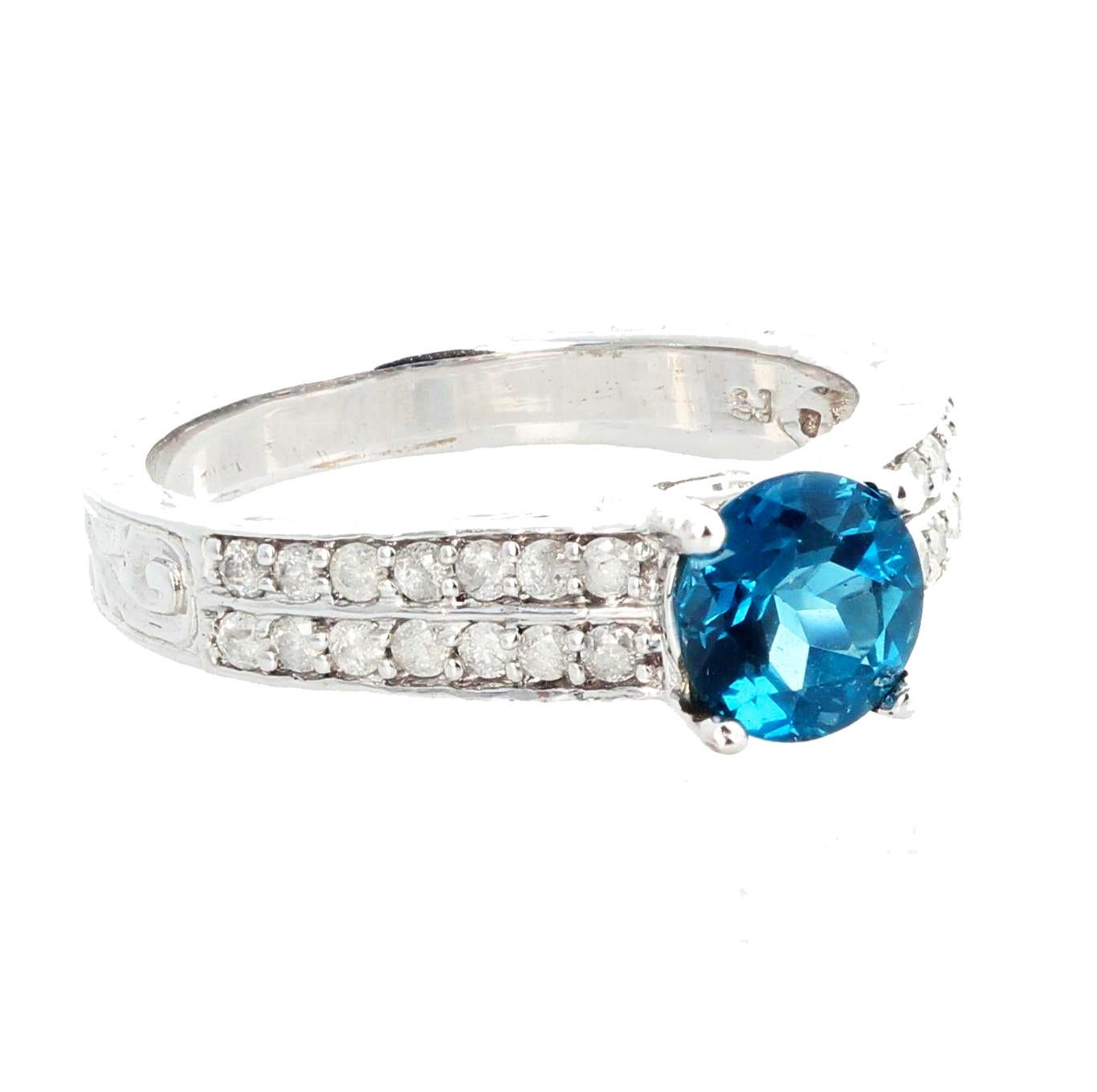 Beautiful gracious glittering blue Topaz - 1.3 carats - 6.5 mm -  set in a 10kt white gold ring size 7.5 (sizable FOR FREE). This gemstone sparkles invitingly and the ring is sizable.  This is really beautiful for wonderful occasions. 