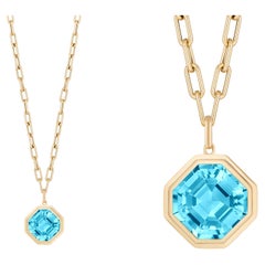 Blue Topaz Asscher Cut Bezel Set Pendant In 18K Yellow Gold