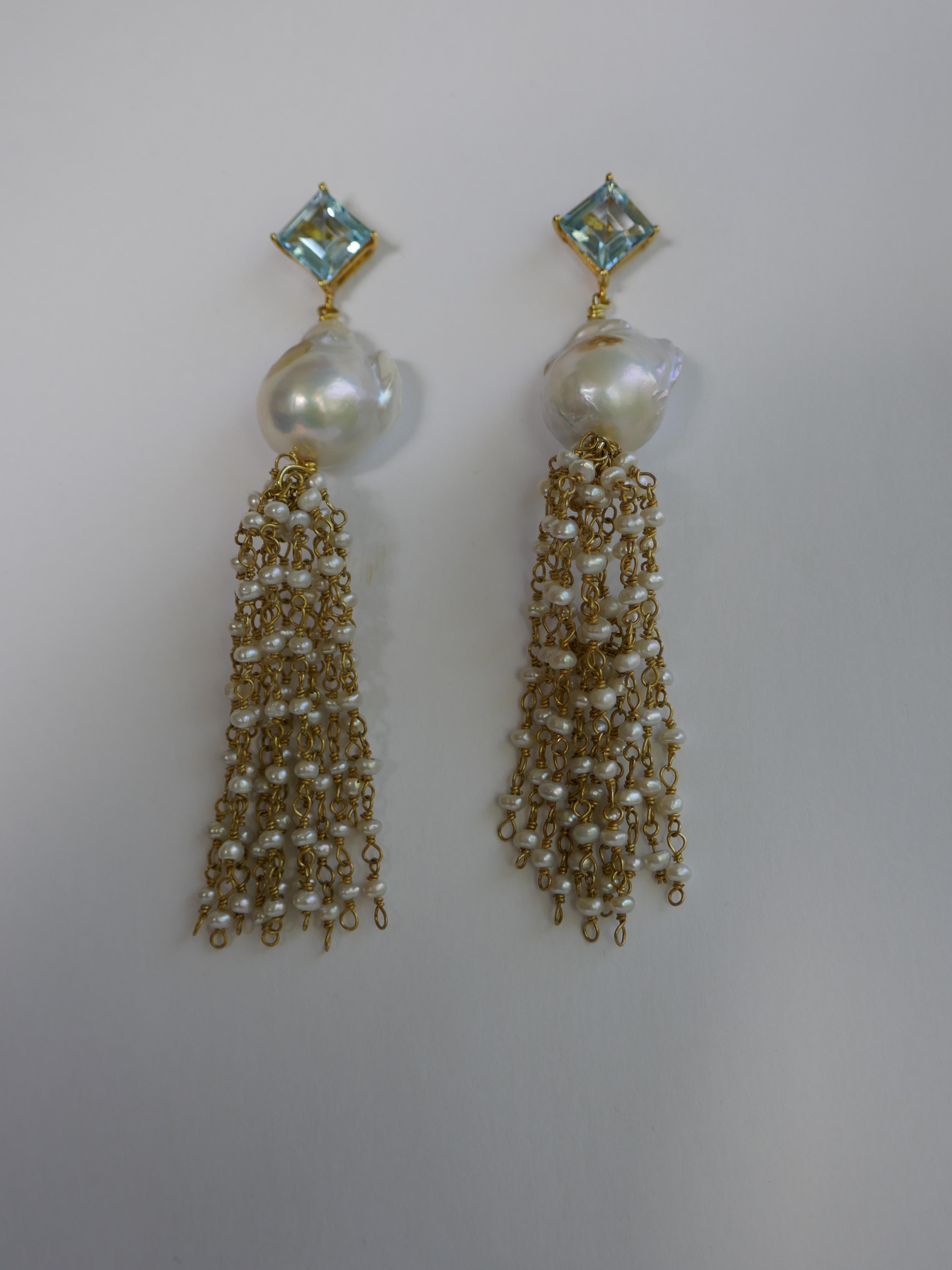 The earrings have a 10x10mm blue topaz  on 14k plated 925 sterling silver post, 14mm baroque cultured pearls and keshi pearls chain tassel. These earrings can be dressed up or down.  The large backs are gold filled.  The earrings are 3.375 inches