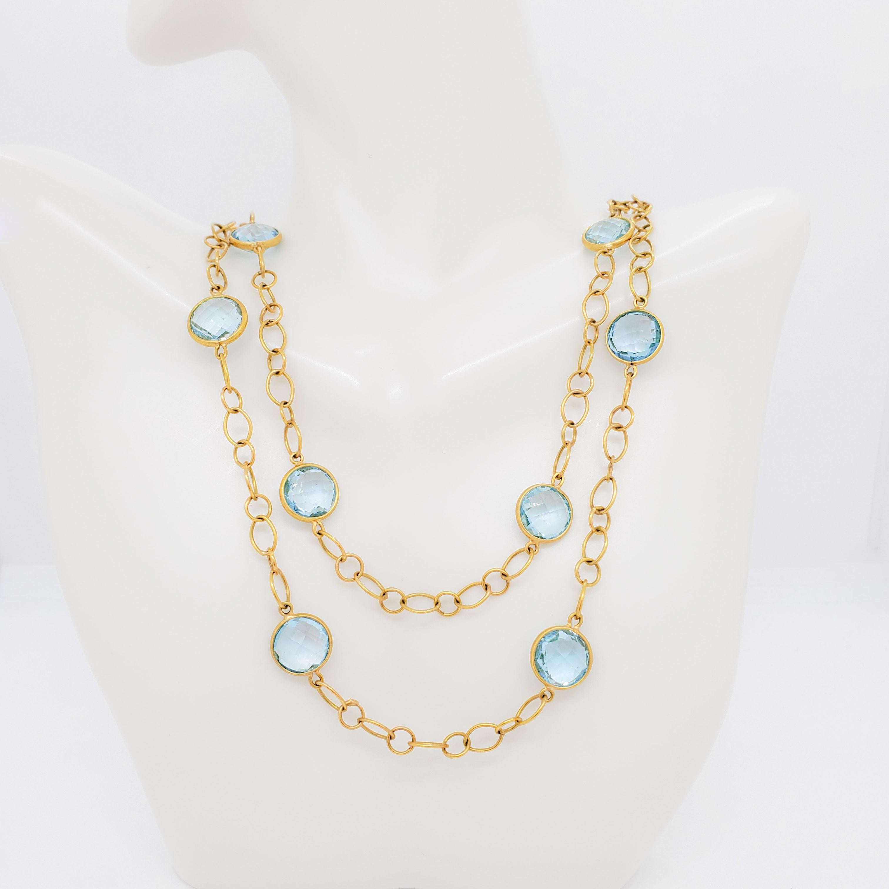 Gorgeous blue topaz rounds in handmade 18k yellow gold bezels and chain.  Length is 36